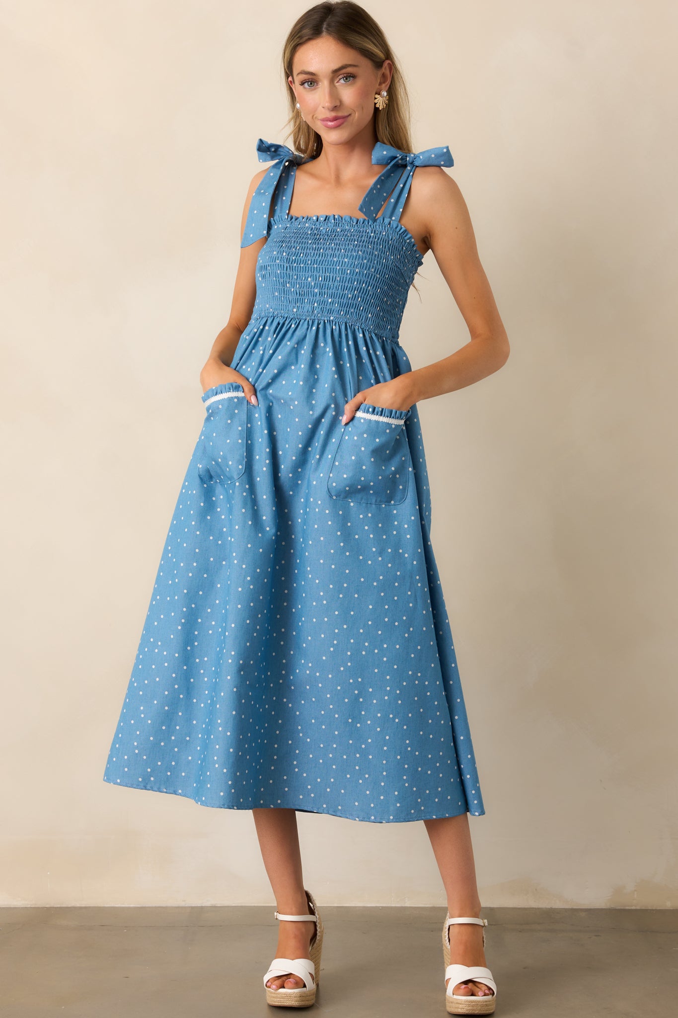 Designed with a straight neckline, smocked bodice, and a relaxed midi skirt for a timeless and effortless look.