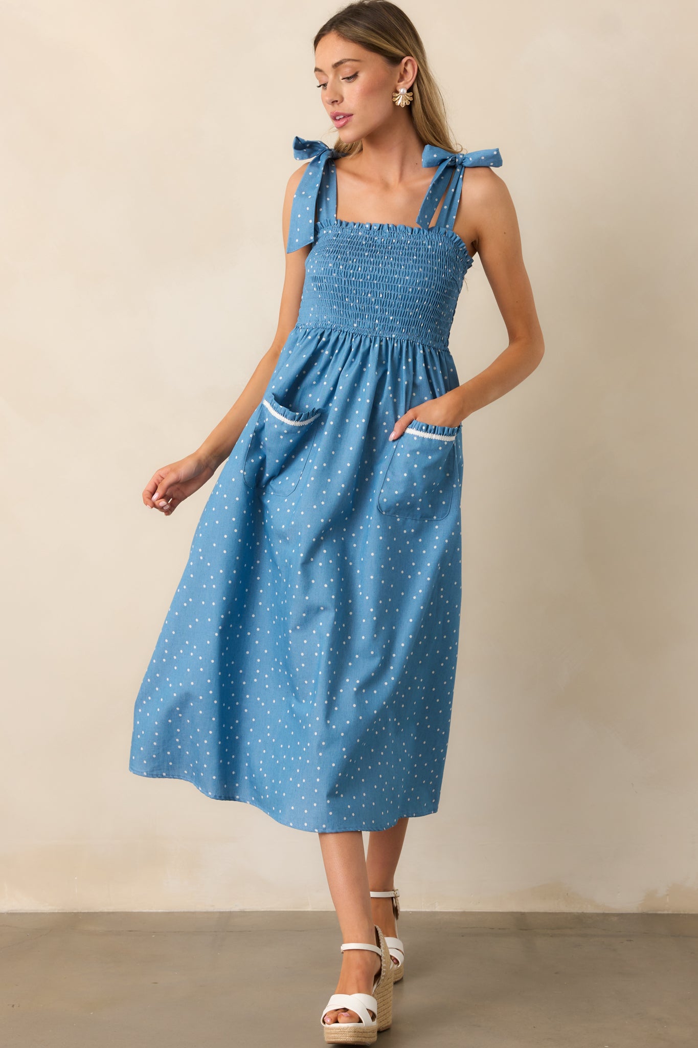 The fitted smocked bodice provides stretch and structure, complementing the flowy skirt