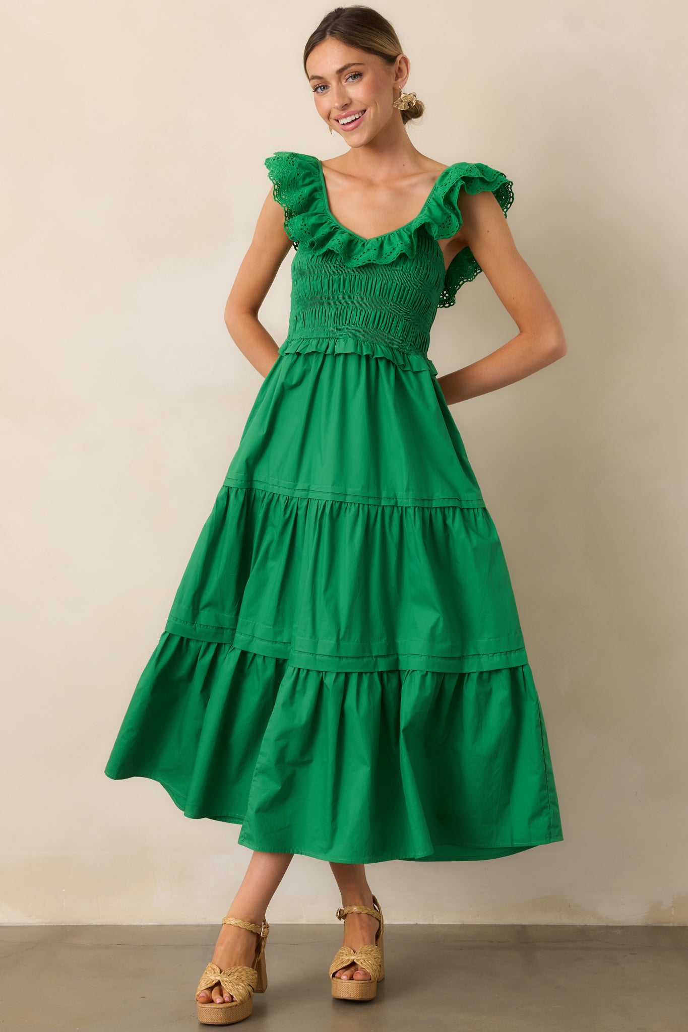 This green maxi dress stuns with its ruffled V-neckline, smocked bodice, and cascading tiered skirt, blending style and comfort.