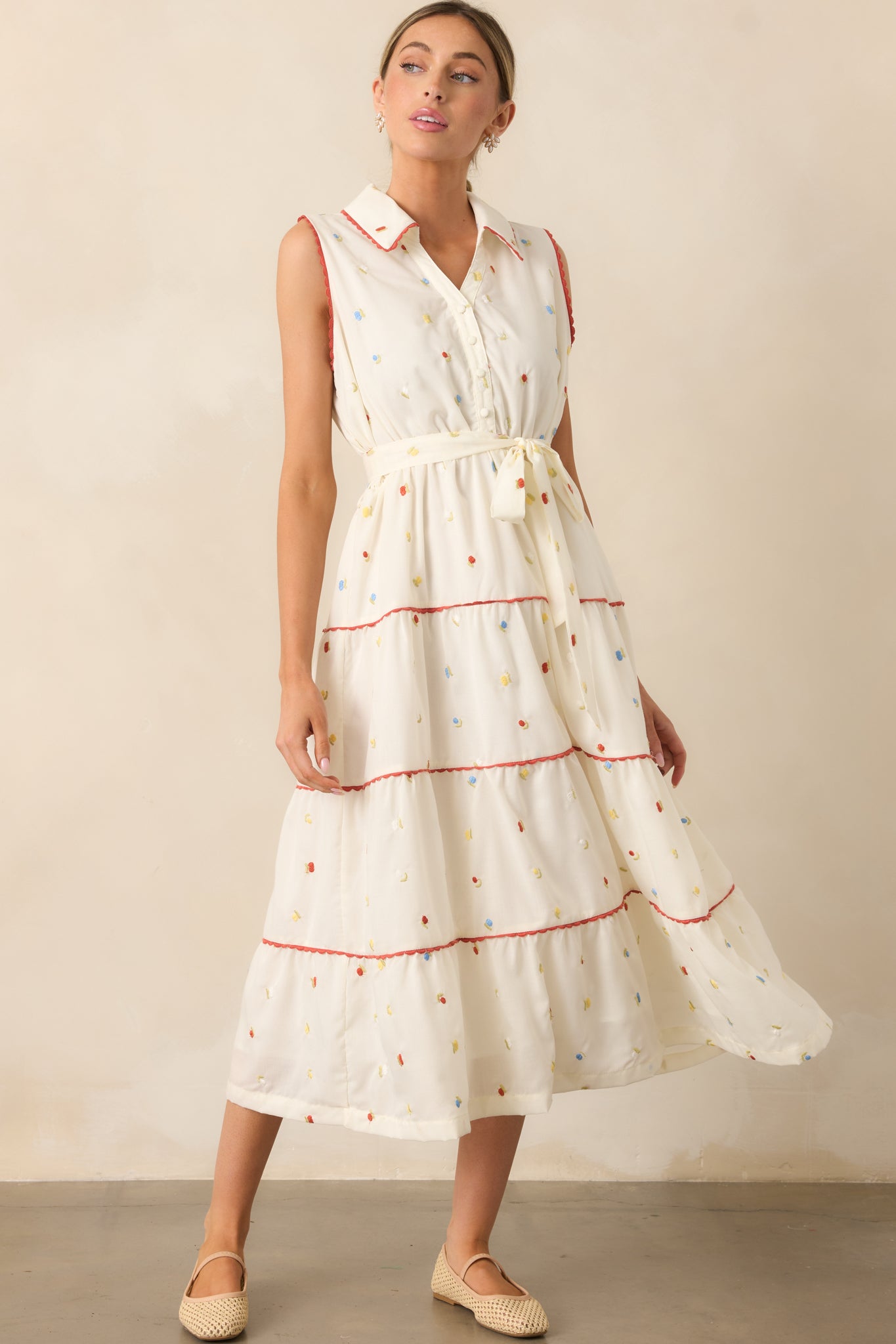 Red ricrac trim outlines the dress, adding a playful and decorative touch to the classic floral print.