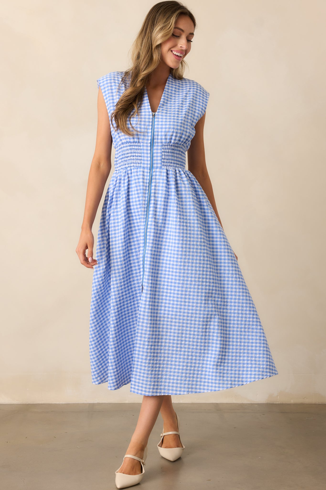 Movement in the fabric highlights the smocked waist and front slit, offering both style and comfort.