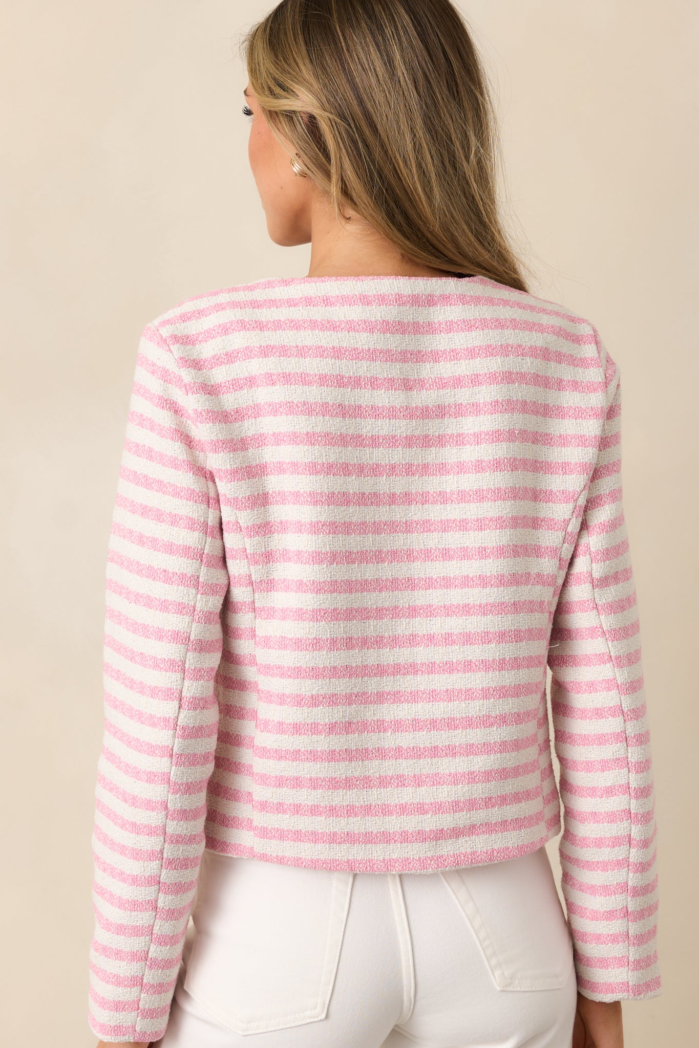 The back of the pink stripe jacket, featuring the smooth finish and continuation of the striped pattern along with the lack of any visible back pockets.