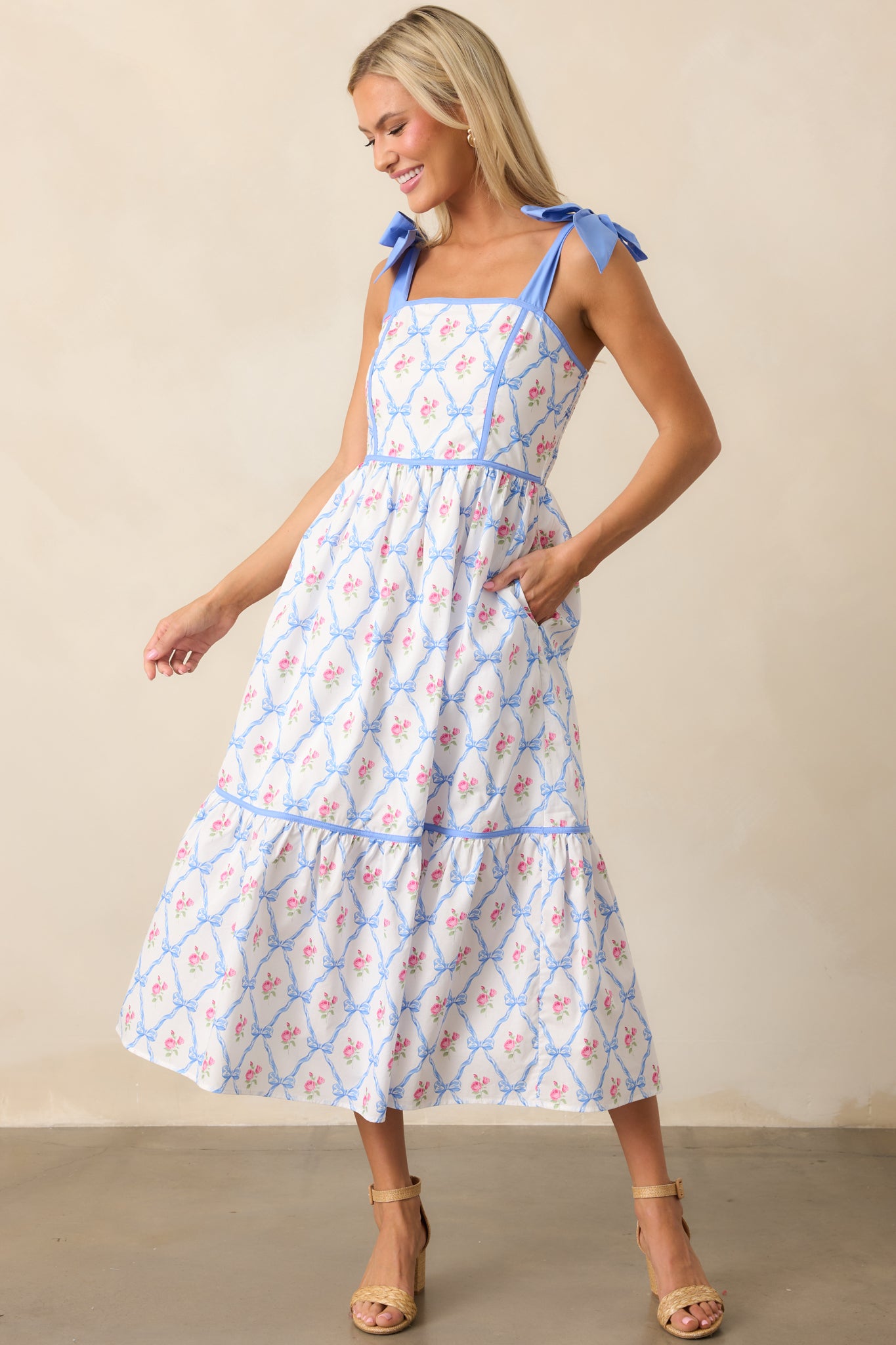 This blue dress features self-tie straps, a square neckline, and smocked back detailing. The addition of functional pockets makes it both stylish and practical.