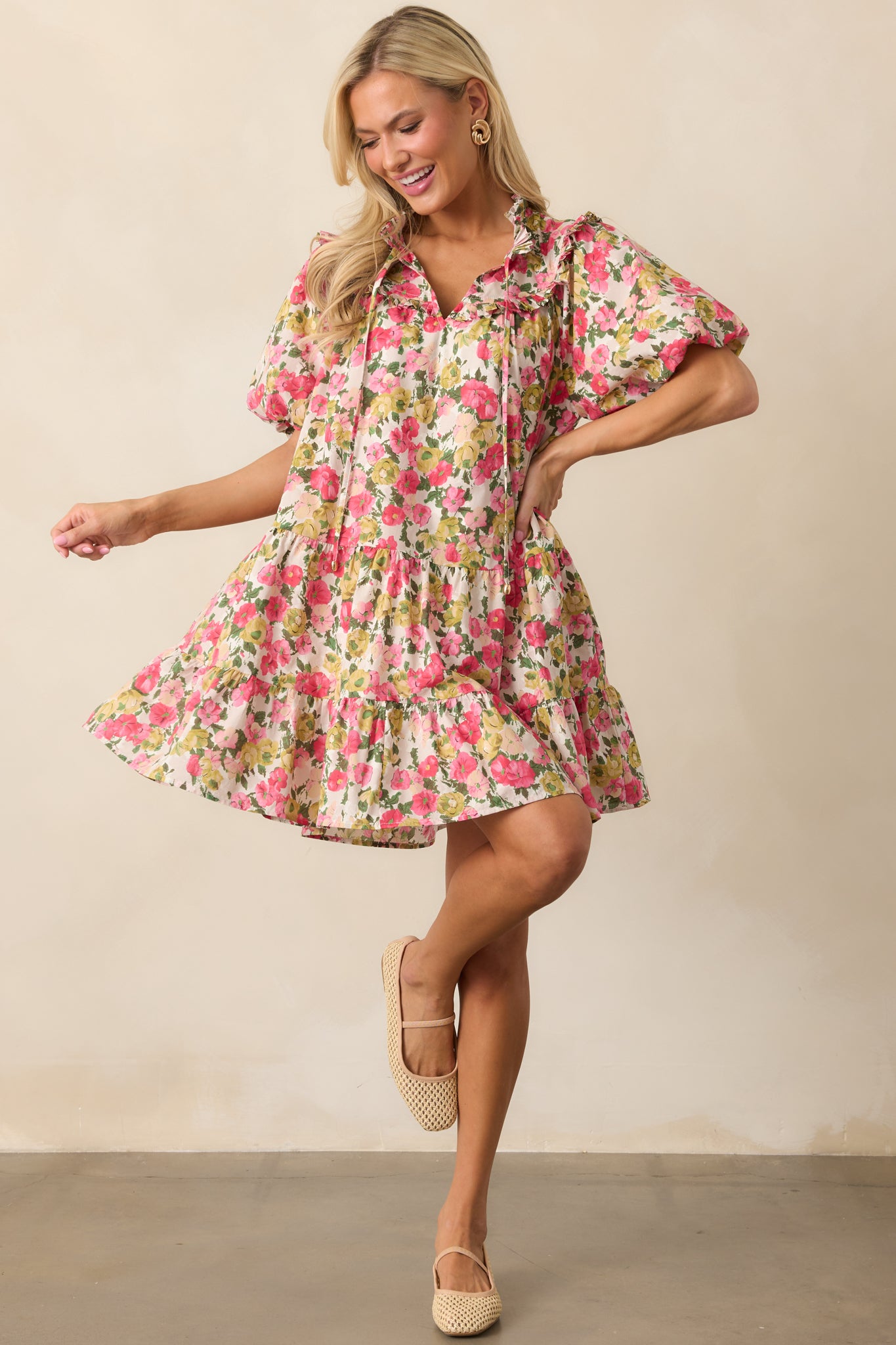 This pink dress features soft tiers, airy puff sleeves, and charming self-tie strings for a sweet, feminine touch.