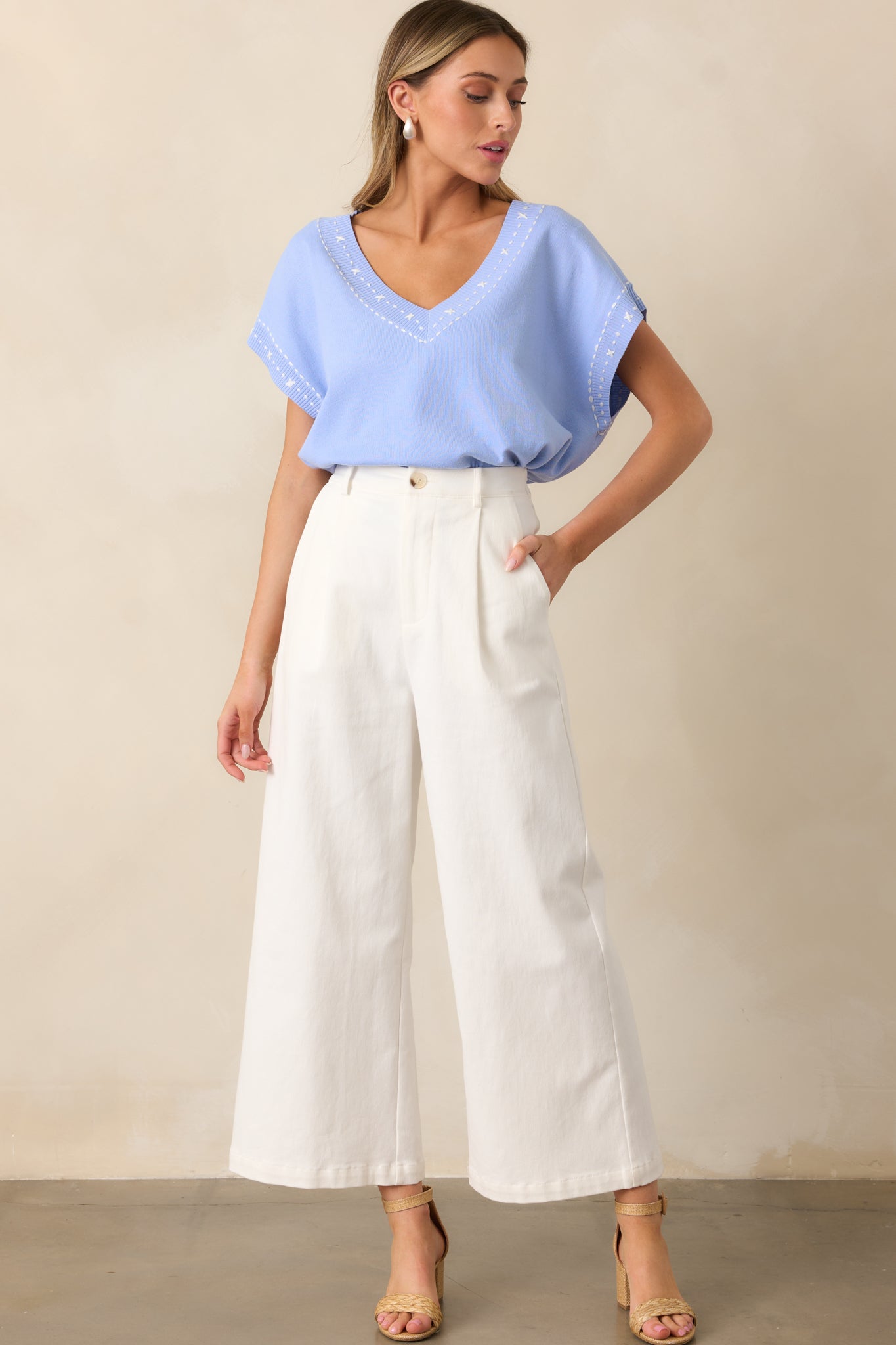  The lightweight material drapes gently, emphasizing the relaxed fit and wide batwing sleeves.