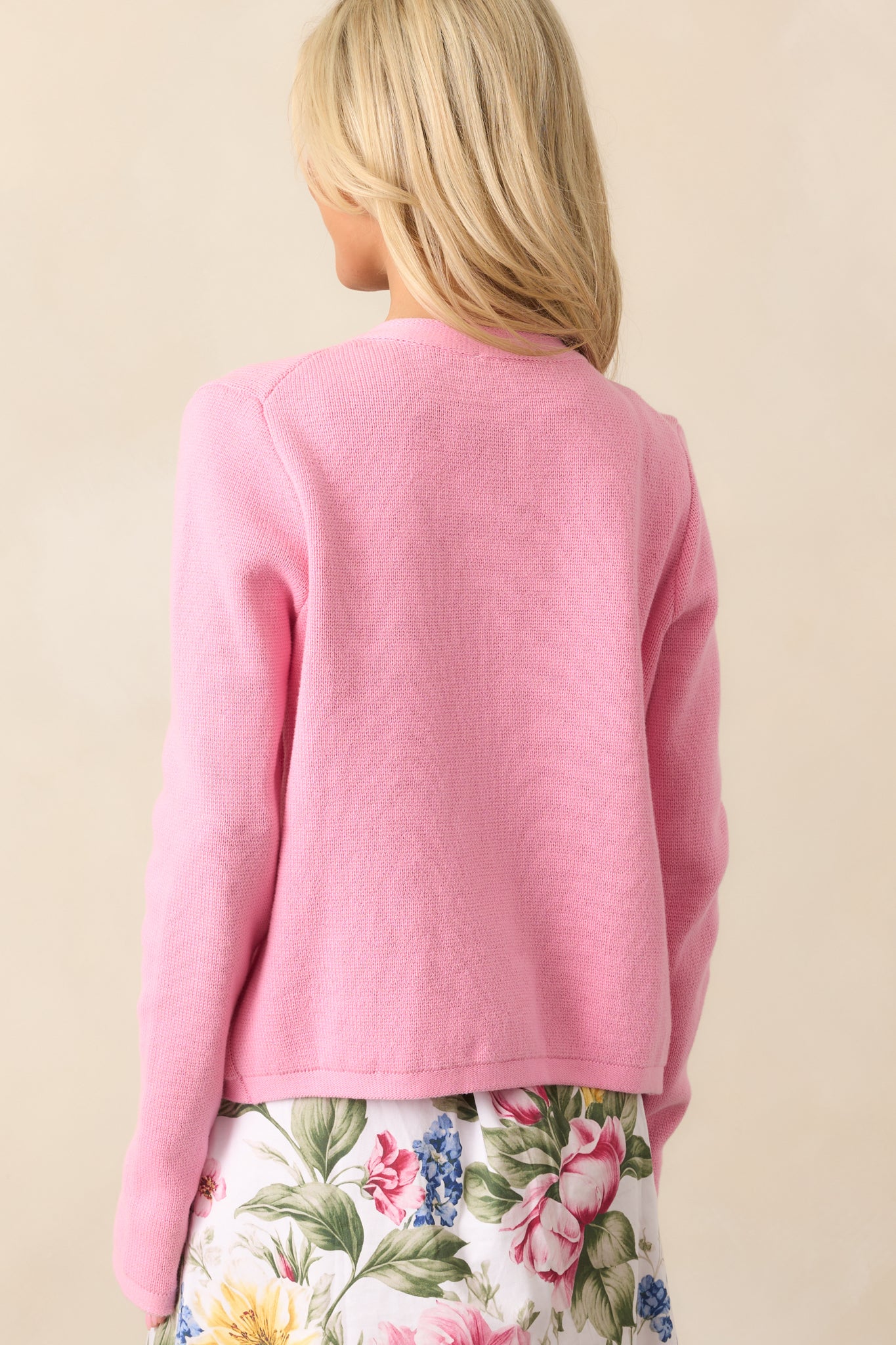  The pink cardigan’s smooth knit continues in the back, completing its effortlessly chic style.