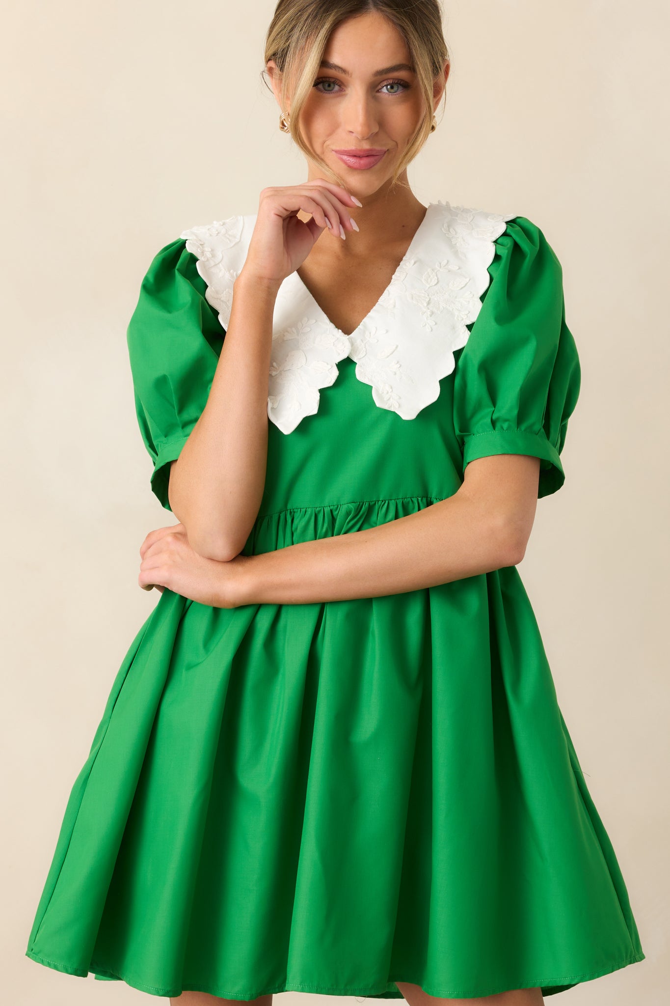 The fitted cuffs on the puff sleeves provide a polished contrast to the airy, babydoll shape of this green dress.