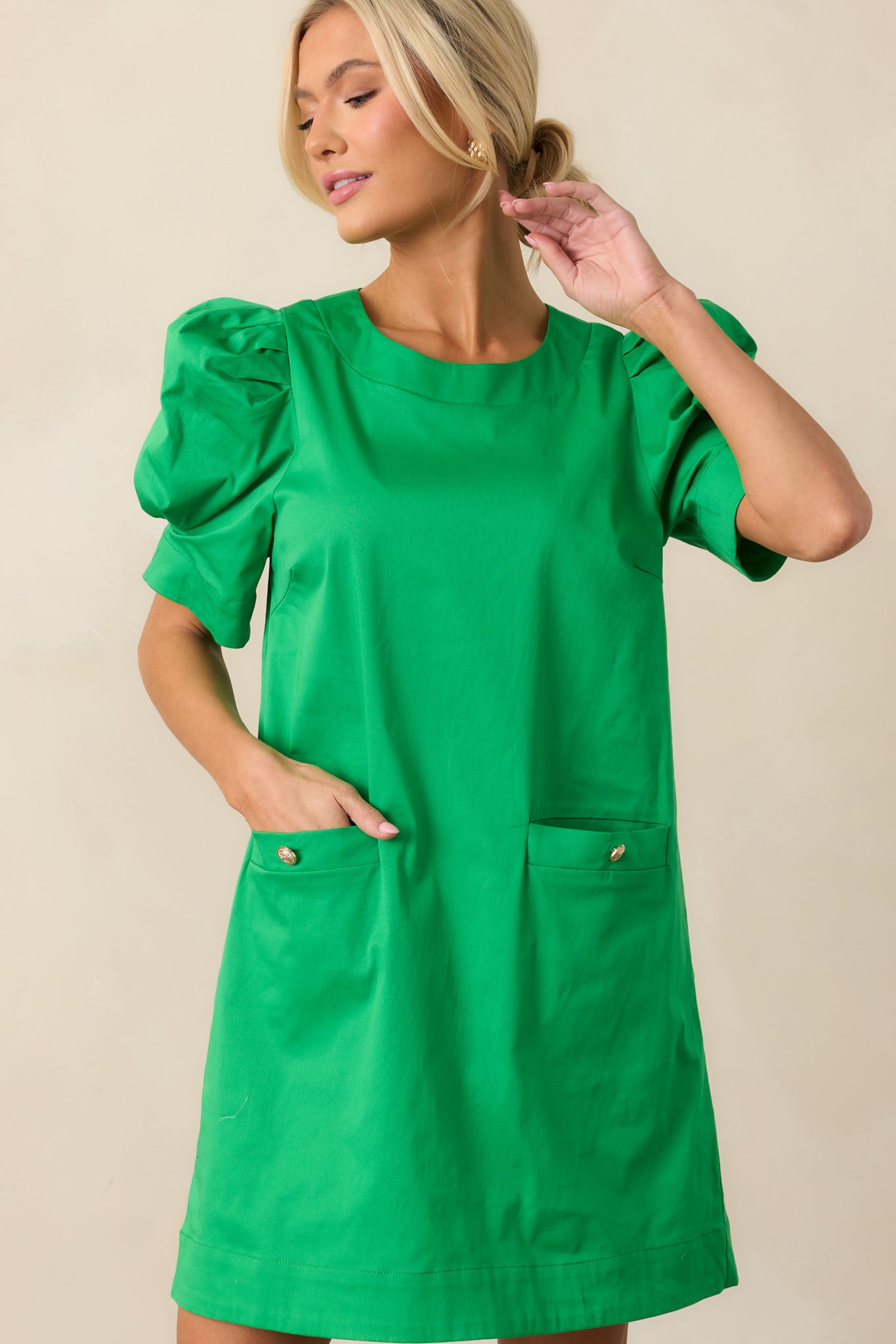 A detailed view of the A-line silhouette, which flows gently from the waist for a comfortable, flattering fit in this green dress.