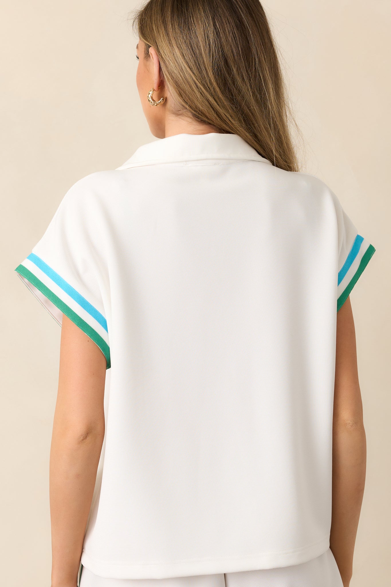 The back of this ivory top continues the green and blue stripe design for a seamless, eye-catching look.