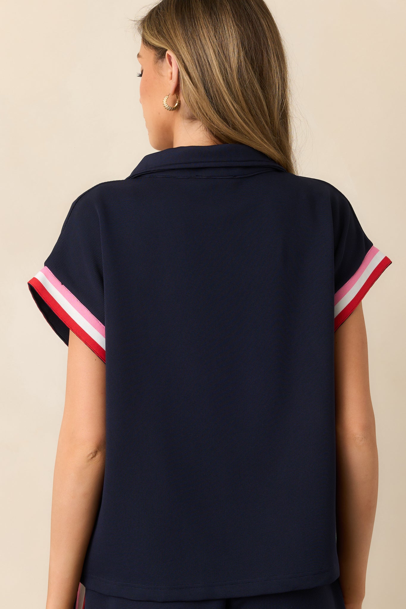 The back of this navy top continues the pink and red stripe design for a seamless and eye-catching finish.