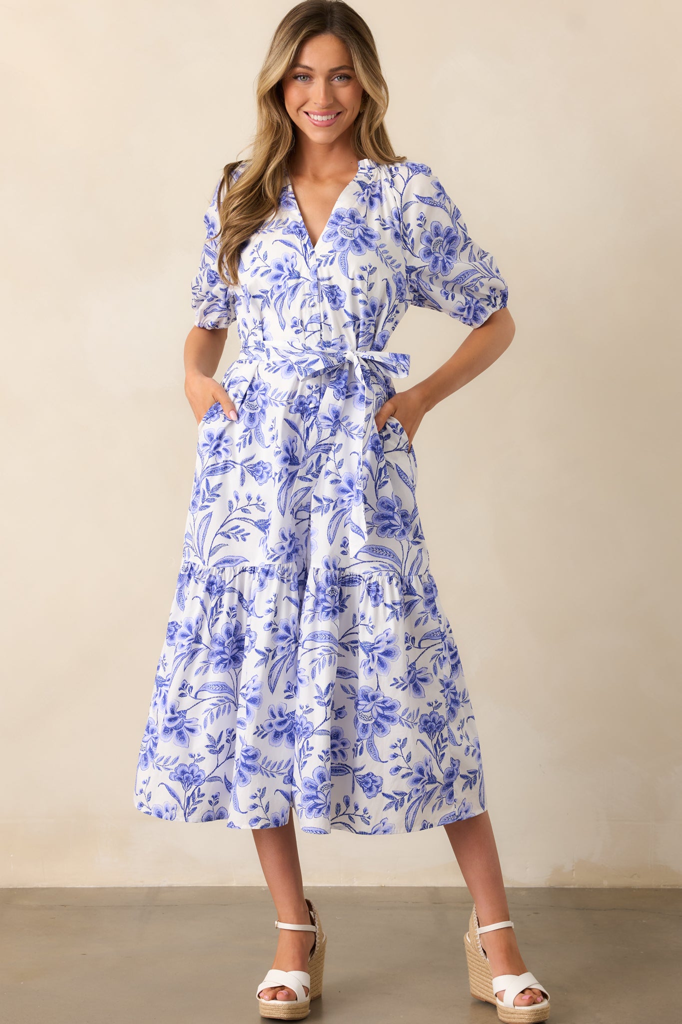  Short sleeves and a V-neckline enhance the airy feel of the dress, with a floral print adding a feminine touch.