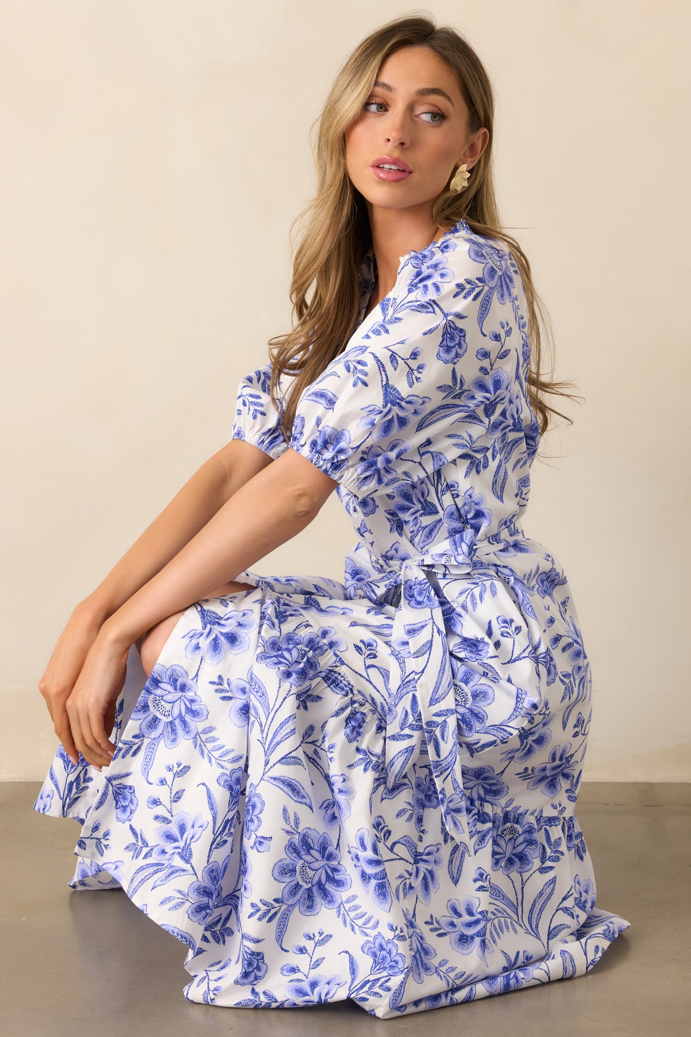 The floral print flows seamlessly across the dress, while the V-neckline, button front, and self-tie waistband create a flattering and feminine shape.