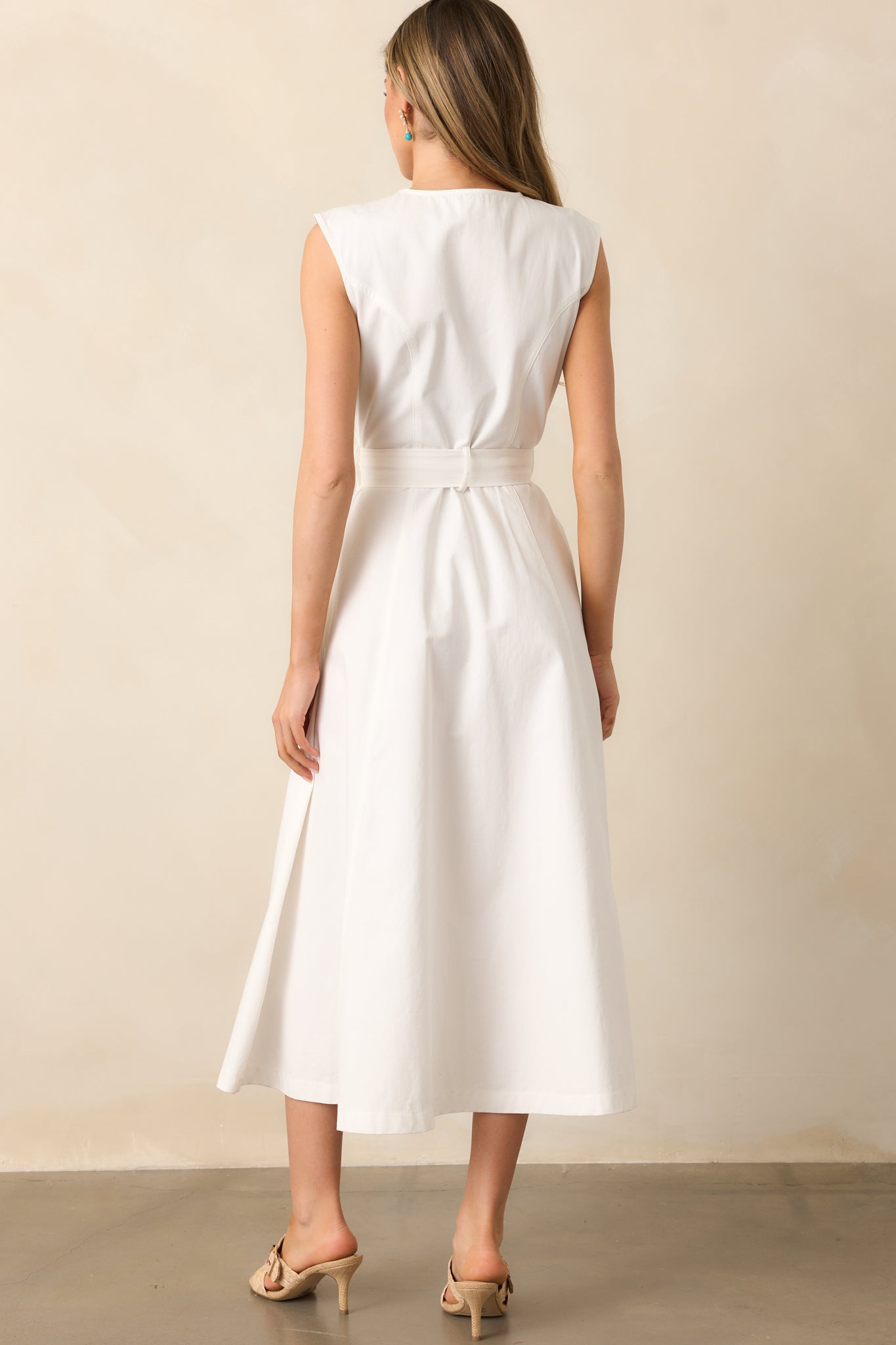 The back of the dress features visible seams, a self-tie belt, and a smooth, flowing midi-length skirt.