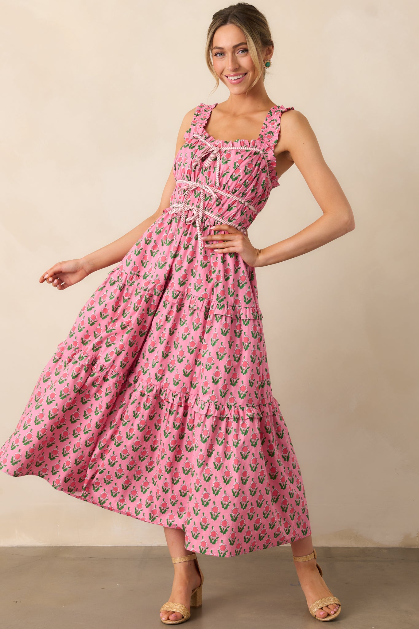 A relaxed and feminine style with a three-tiered skirt, empire waist, and sweet bow tie detailing that cinches the waist for a flattering fit.