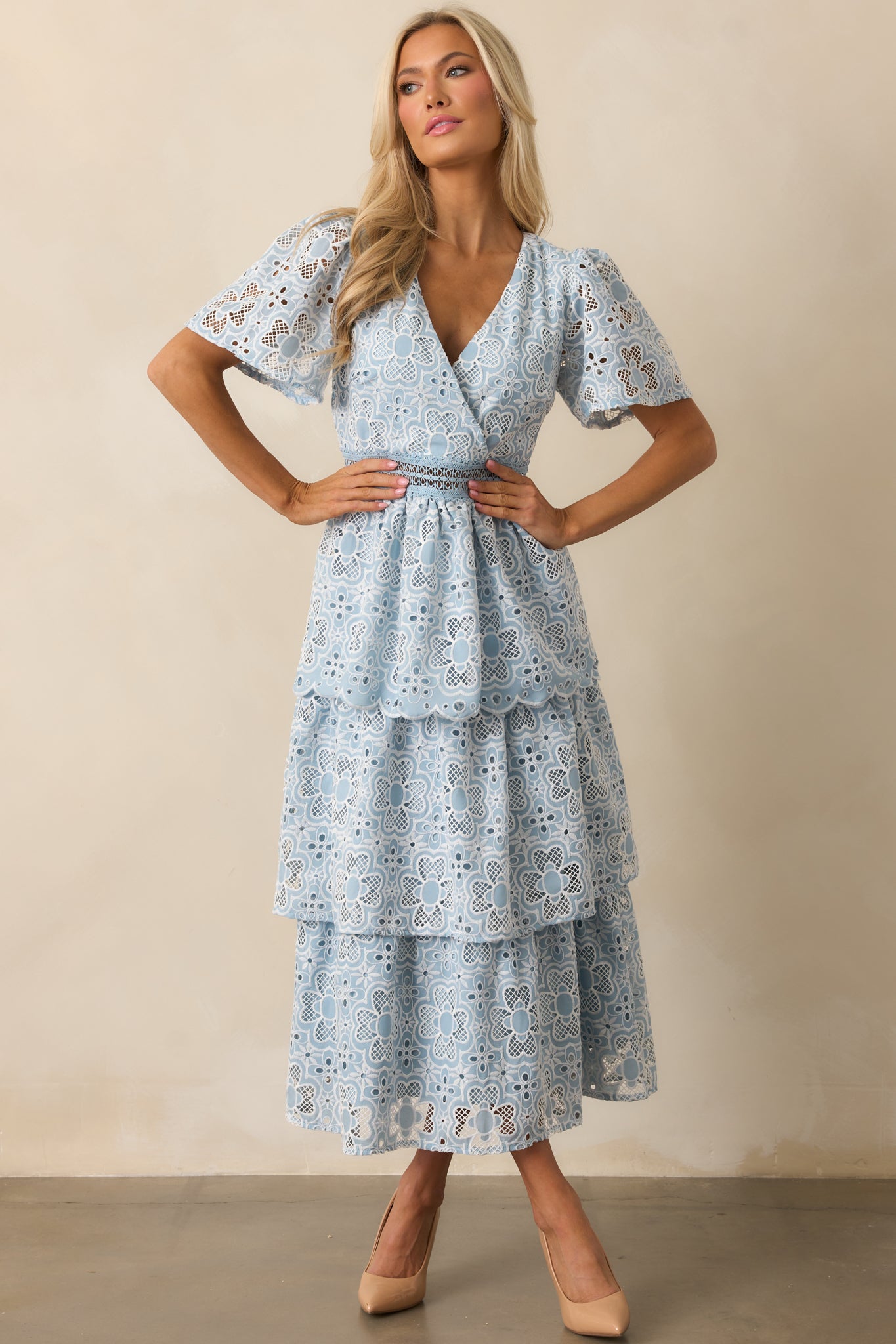 This blue dress features a charming tiered design and a v-neckline, making it effortlessly stylish.