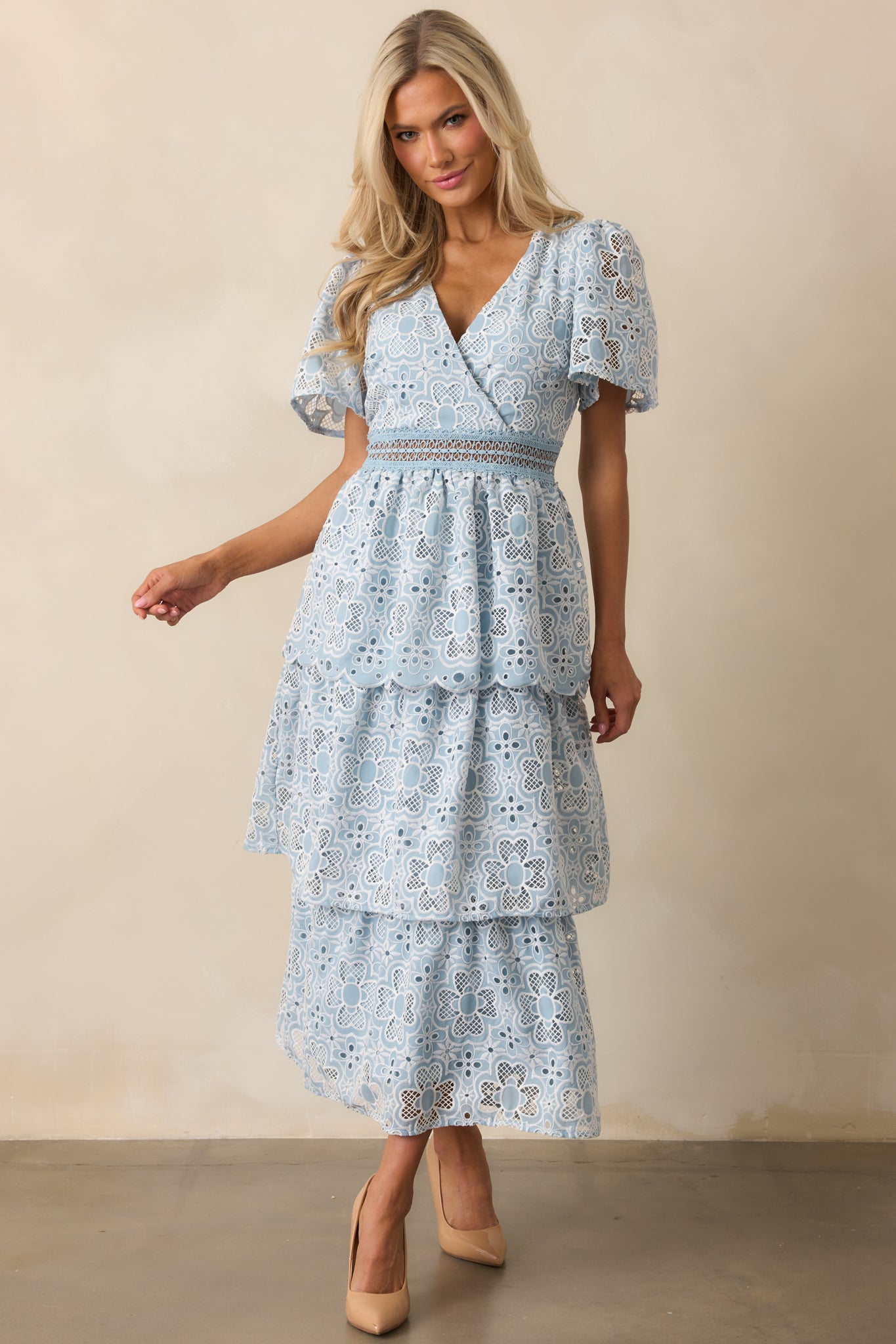 The blue dress showcases its v-neck neckline and short sleeves, offering a light and airy feel.