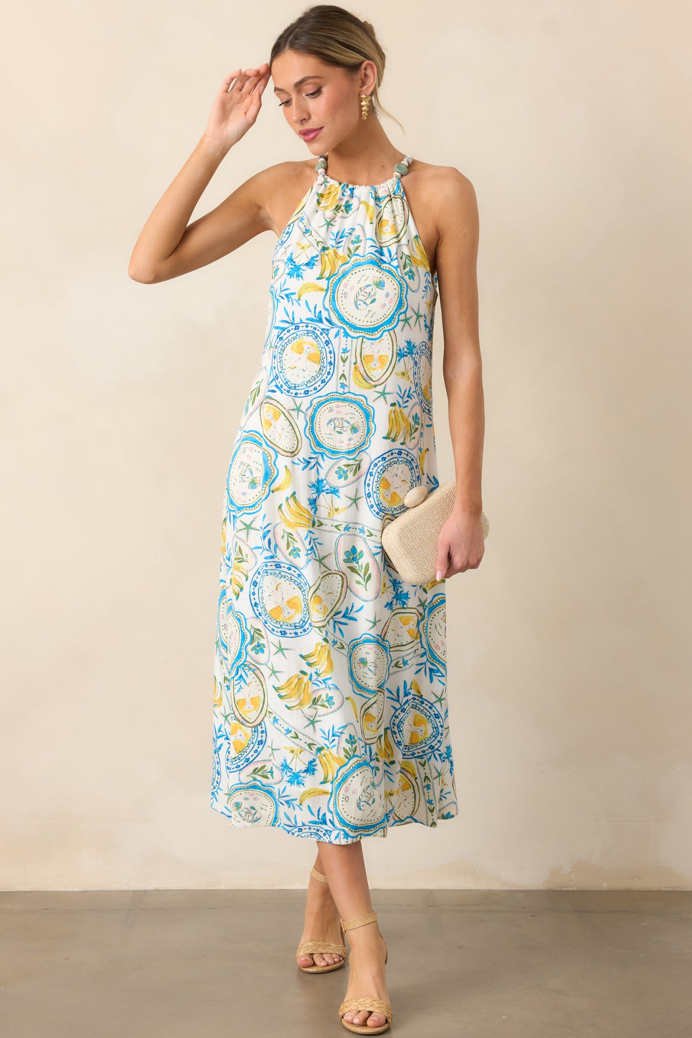 Another front view of the dress, showcasing the vibrant tropical print with blue and yellow tones and the smooth flow of the fabric.