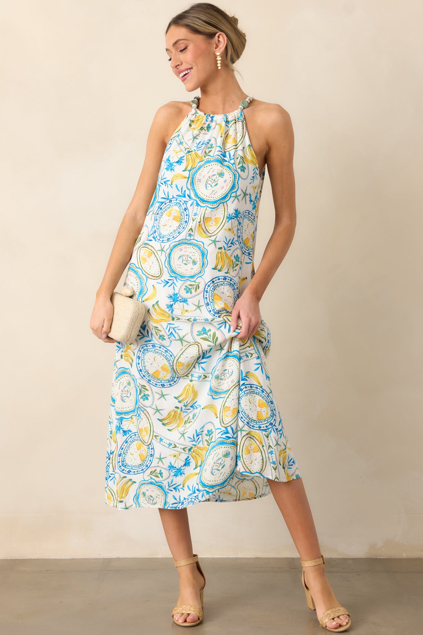 A complete view of the blue and yellow dress, showcasing the relaxed silhouette and the elegant midi length.