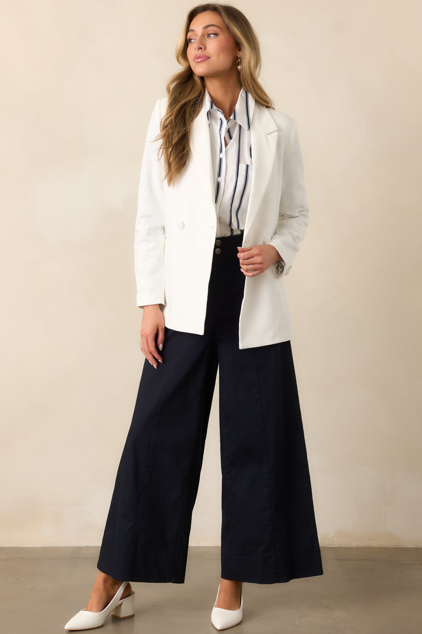 Another front shot of the white blazer highlighting the functional pockets and lightweight shoulder pads.