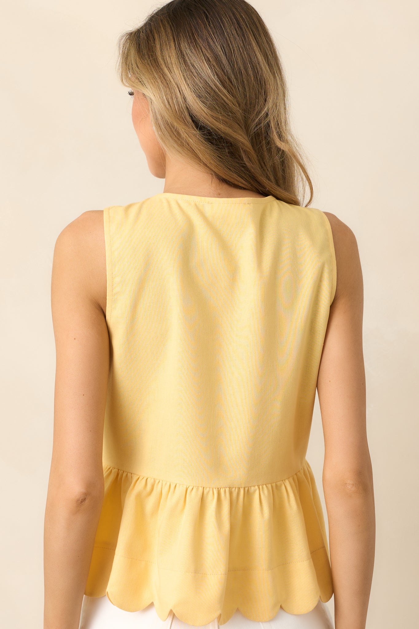 The back of the yellow top remains sleek and simple, letting the front design take center stage.