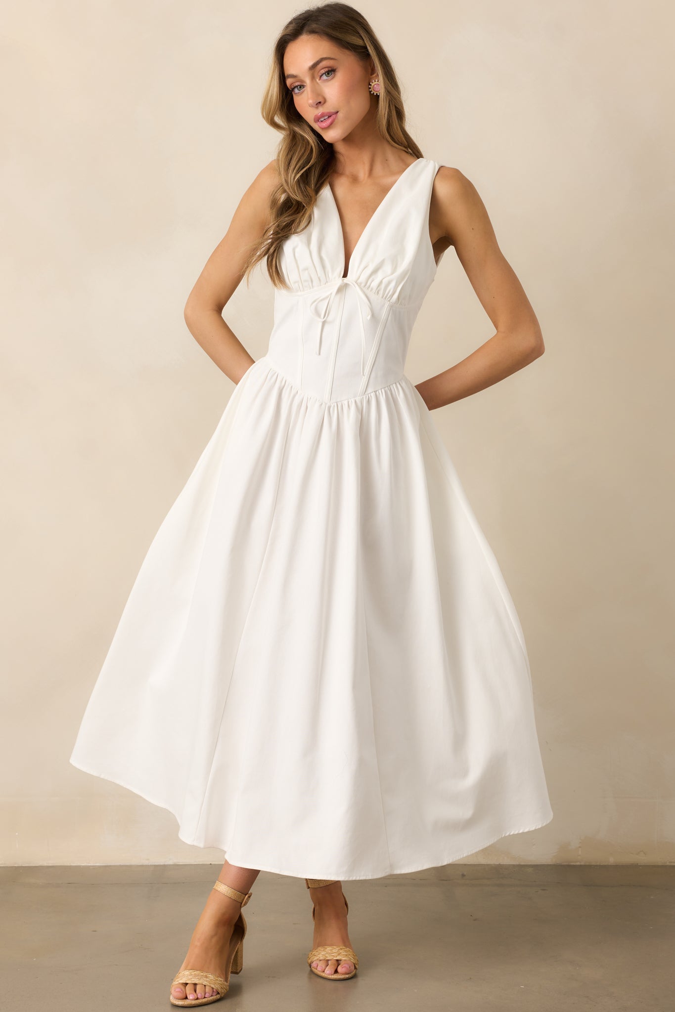 Classic white dress with a fitted corset waist, designed to enhance the silhouette with graceful structure.