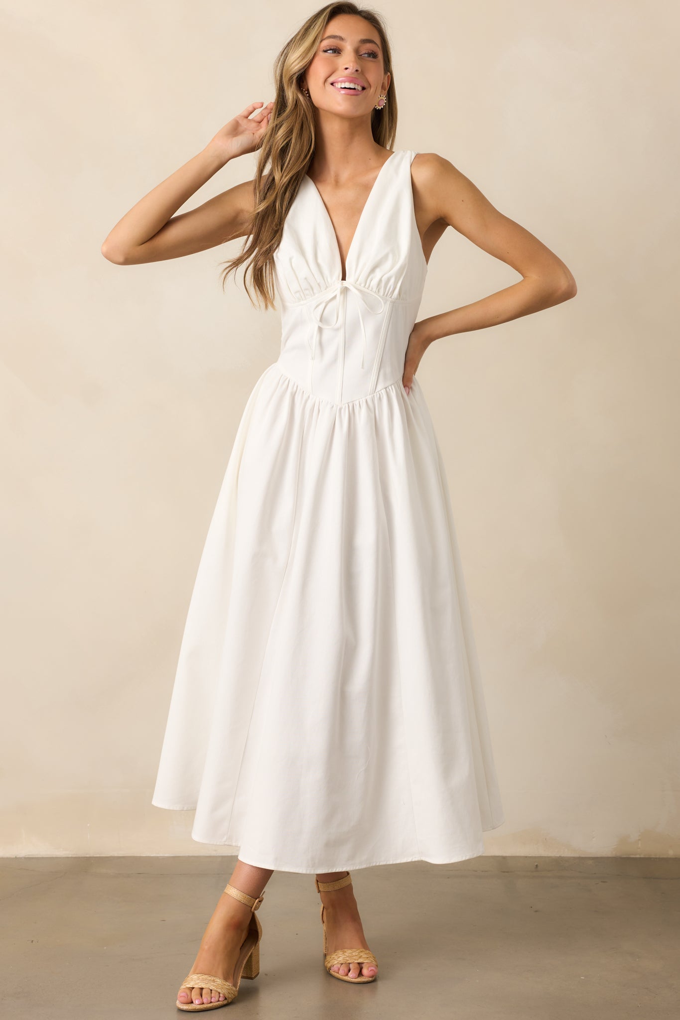 A graceful white dress with a tailored fit, corset detailing, and a refined, elegant aesthetic.