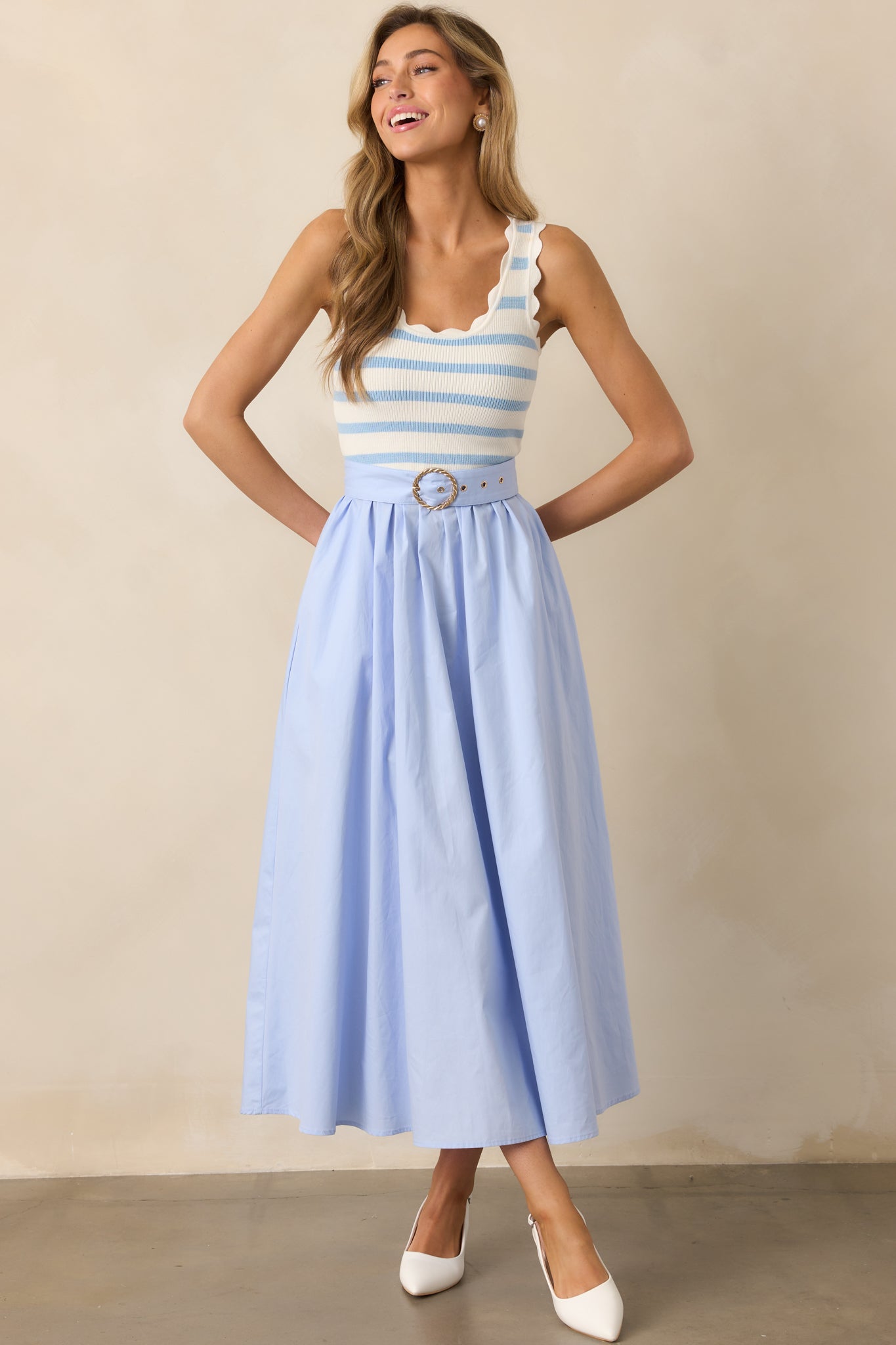 Elegant midi dress featuring a solid blue skirt and an optional belt for a customizable fit.