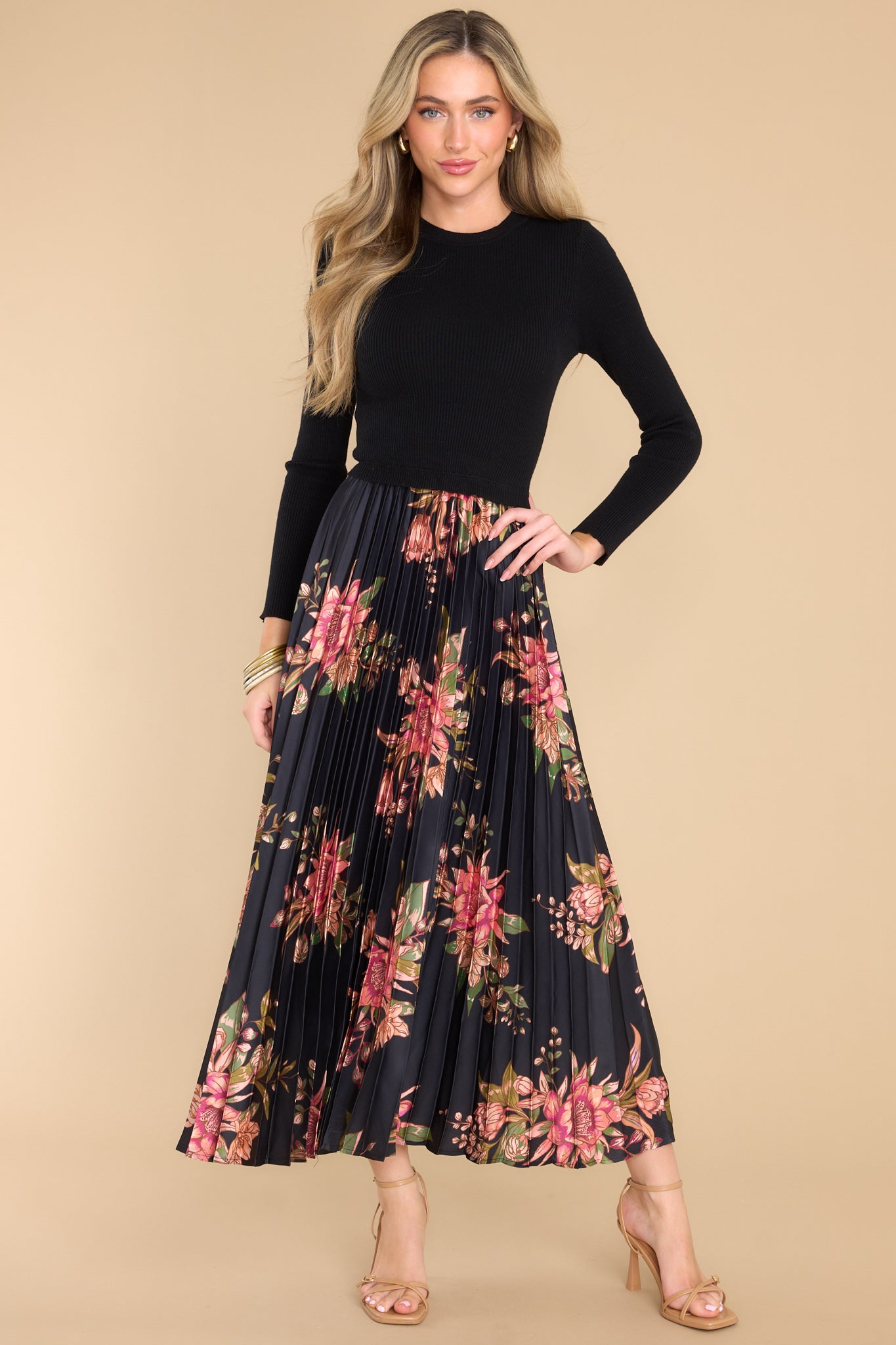 Full body view of this dress that features a pleated floral satin like skirt.