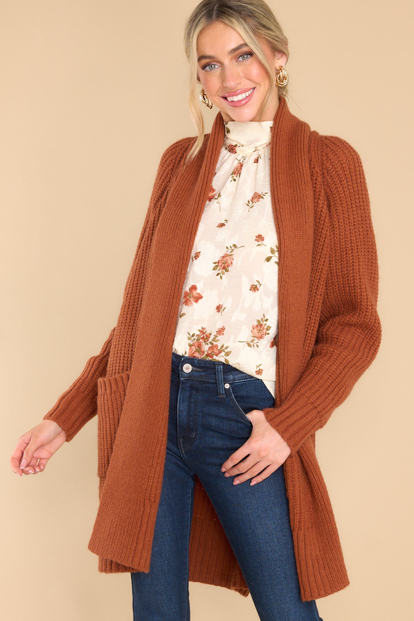 Front view of this cardigan that features a folded neckline that extends down the front, functional pockets, and a knit texture throughout.