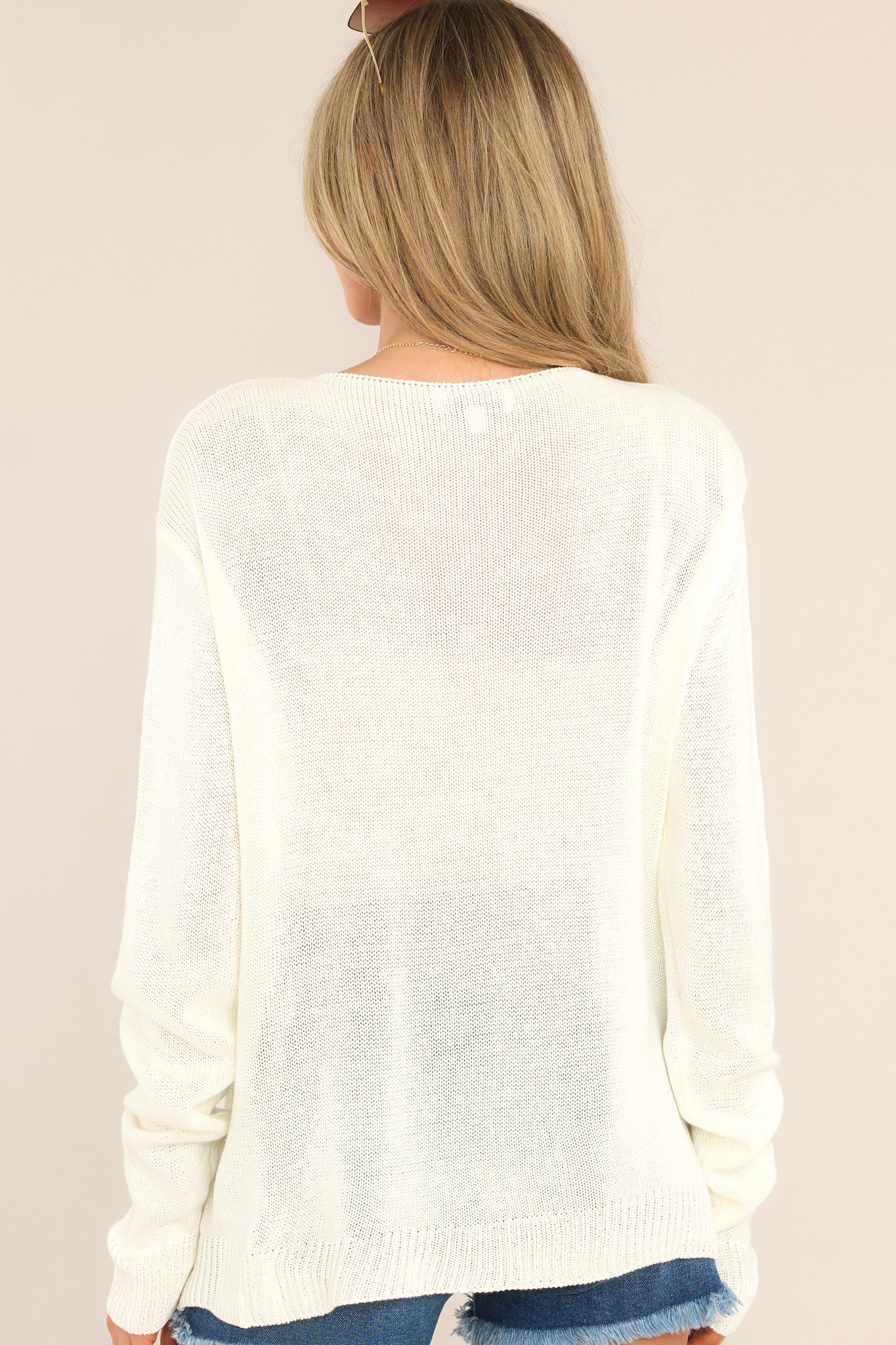 Back view of this top that features "Sunny Days Club" on the front, a light weight knit fabric, ribbed cuffs, and a ribbed bottom hem.