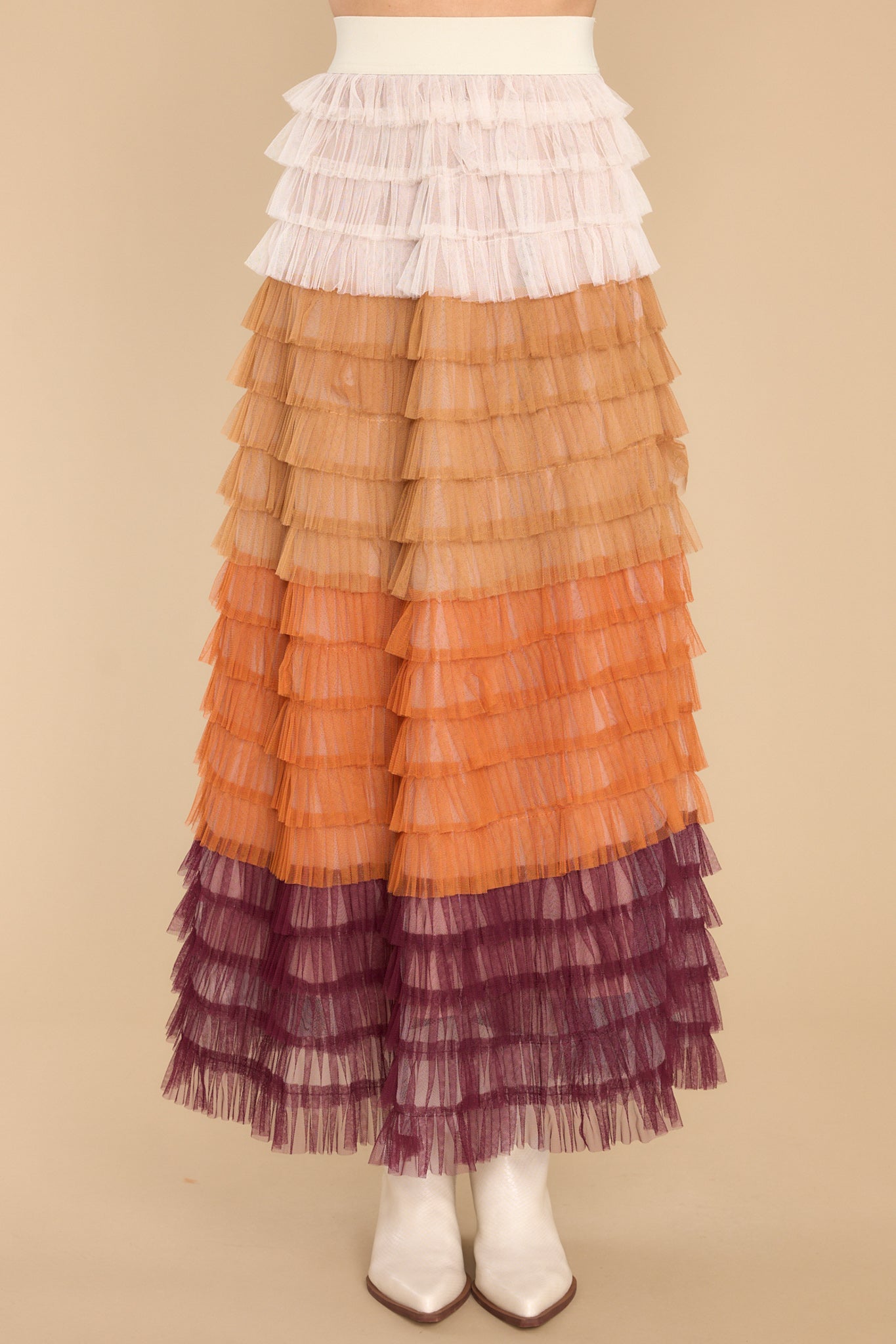 Front view of this skirt that showcases the shades of cream, orange, and burgundy.