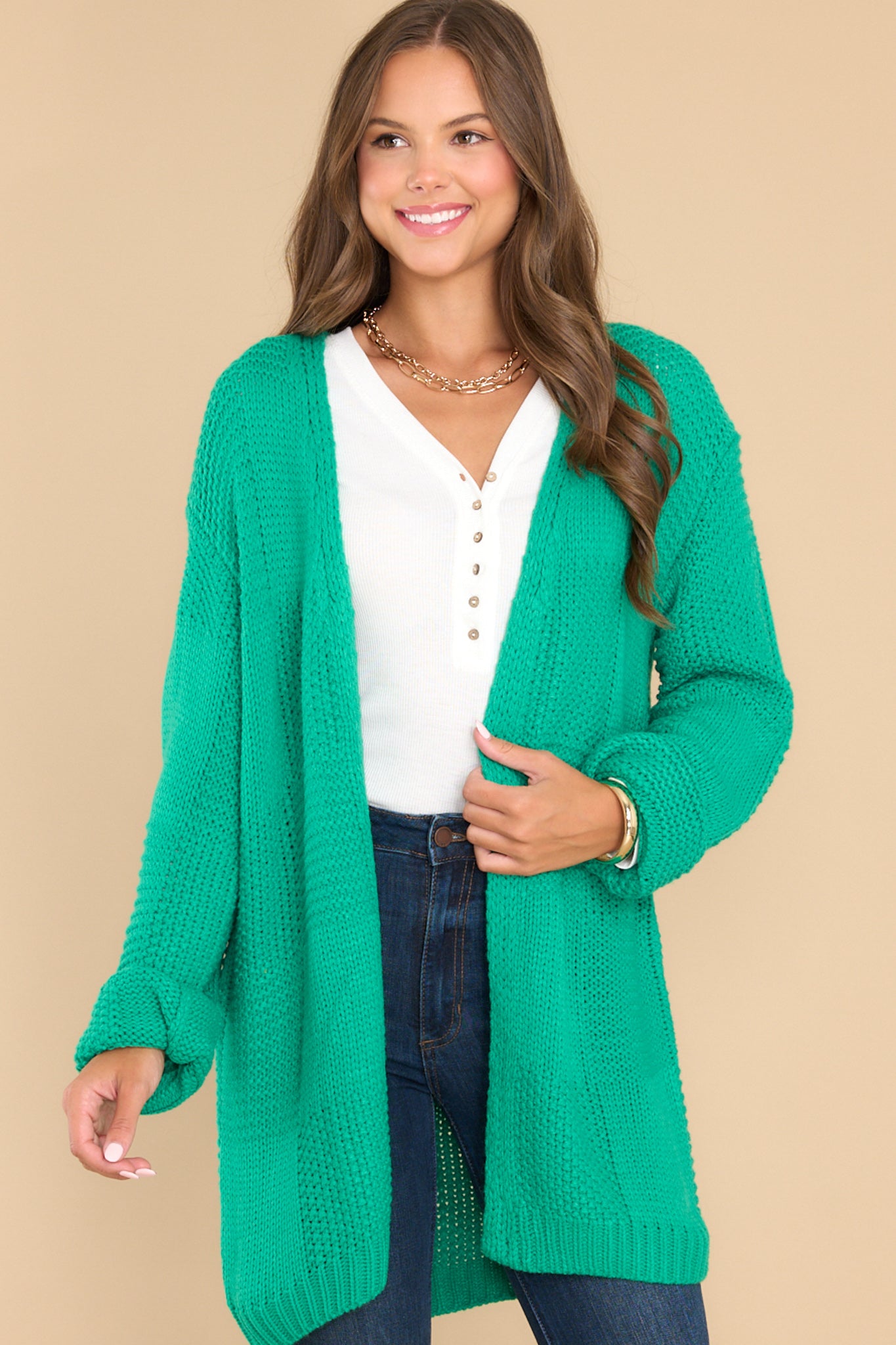 Front view of this cardigan that features a chunky square knit design with long sleeves and ribbed cuffs.