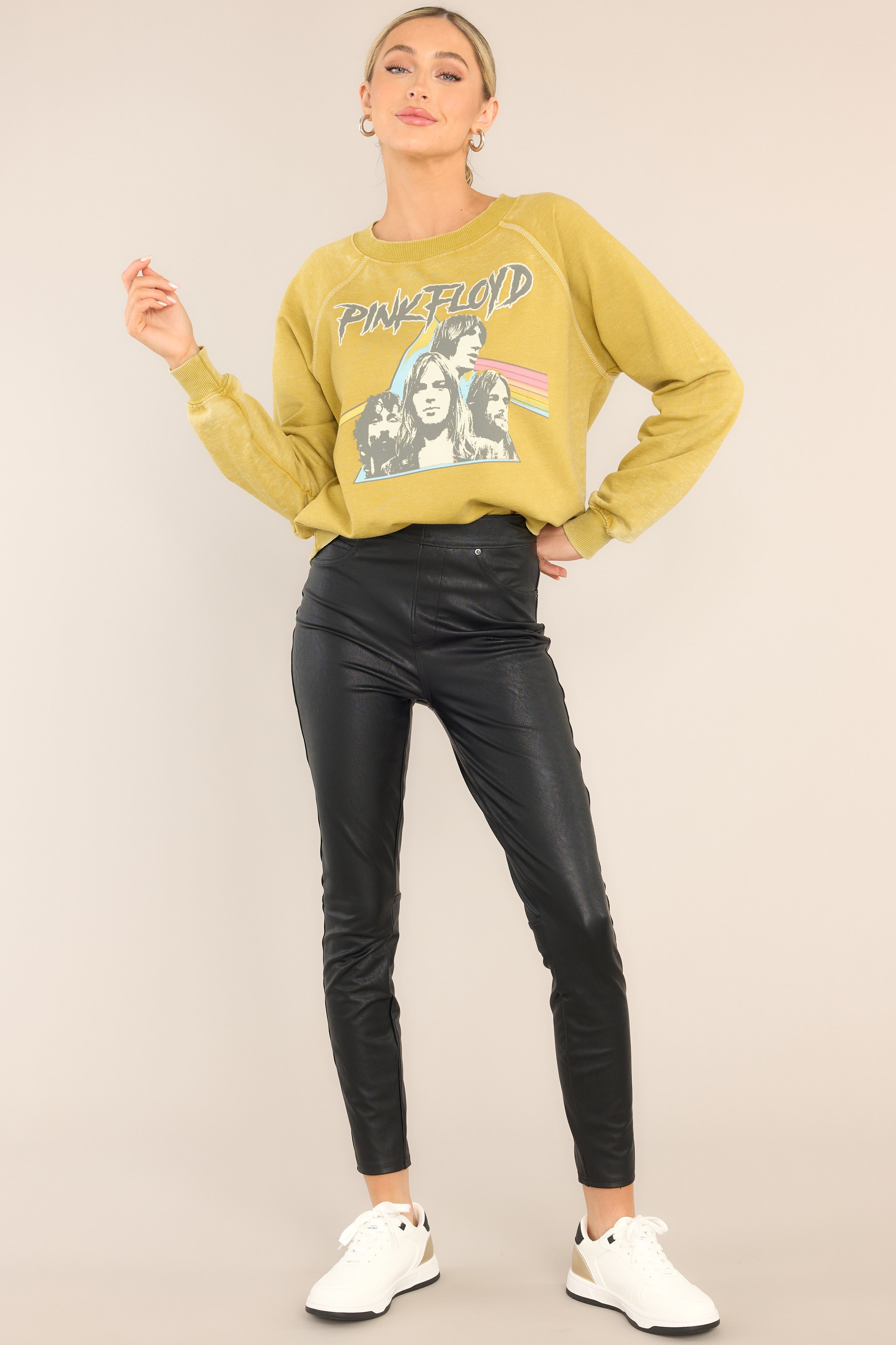 Full body view of this sweatshirt that features a ribbed crew neckline, exposed seams, graphic of the band members, "Dark Side of The Moon" album cover art, cuffed long sleeves, and a ribbed hemline. 