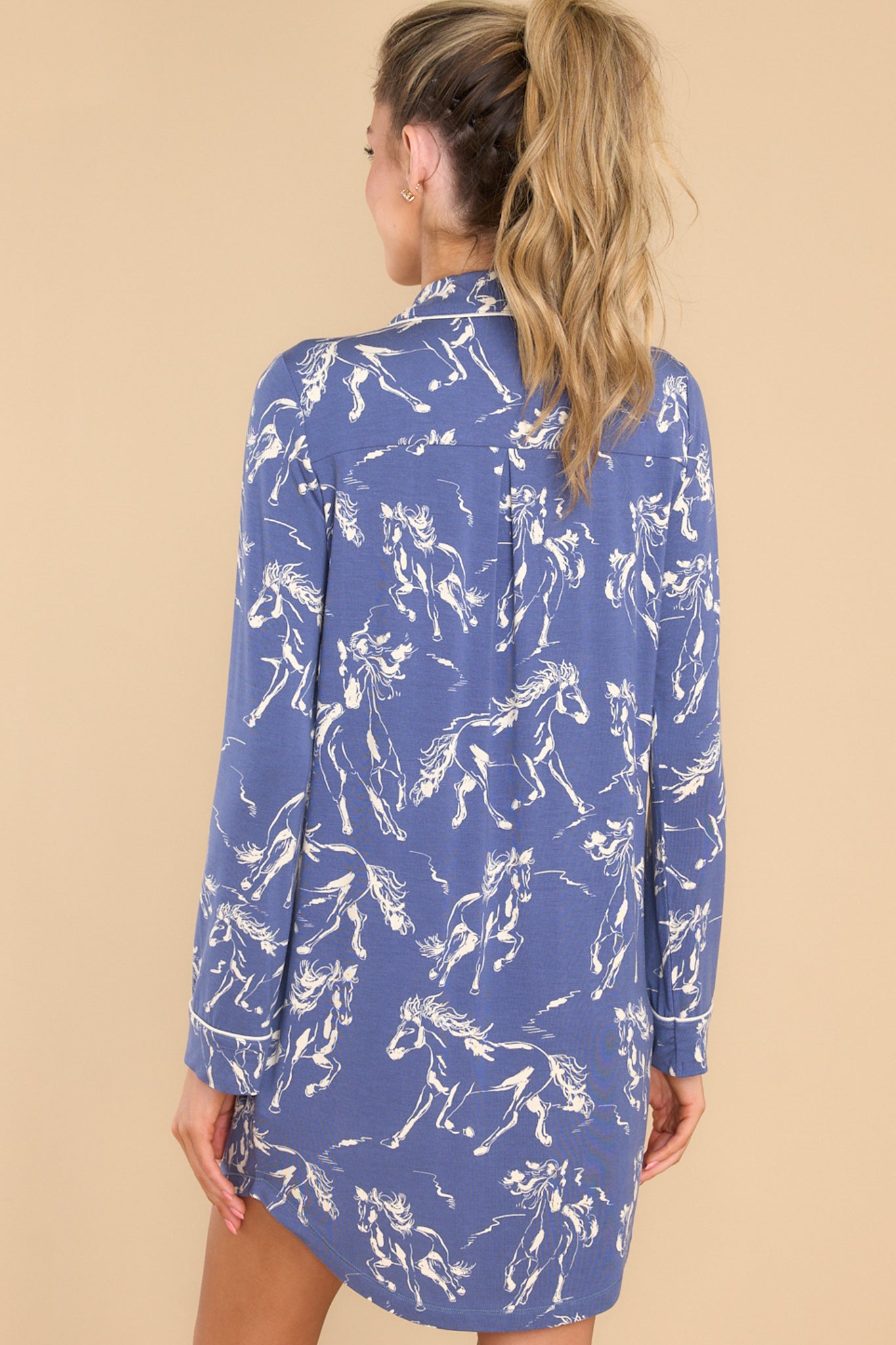 Back view of this nightshirt that features a collared neckline, functional buttons down the front, a functional front pocket on the left side of the bust, and a round hem.