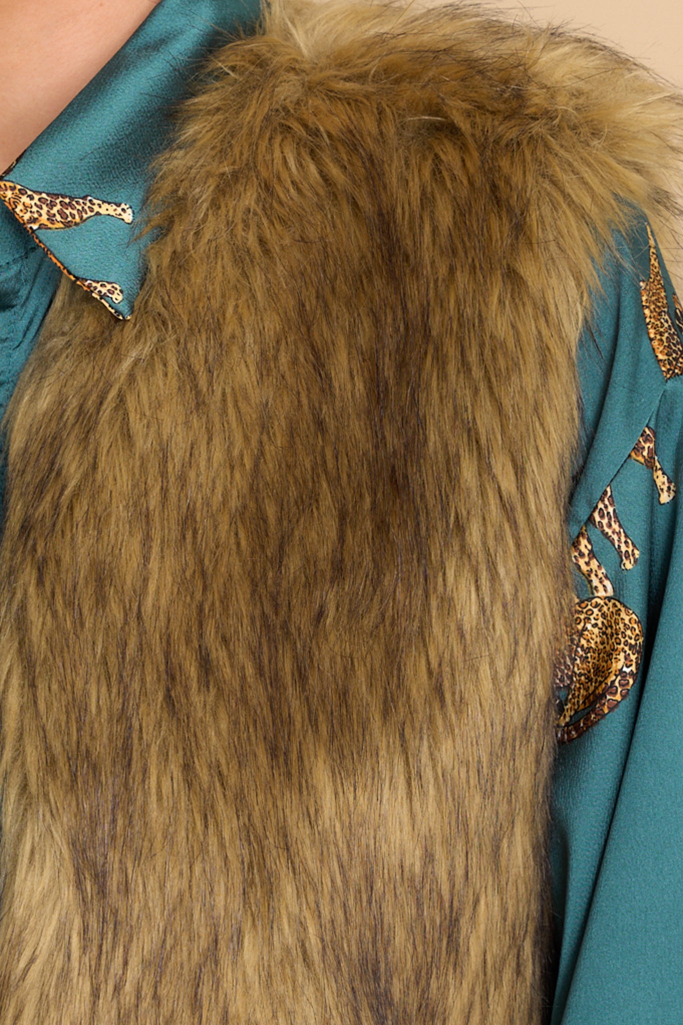 Close up view of this vest that features a scoop neck and faux fur.