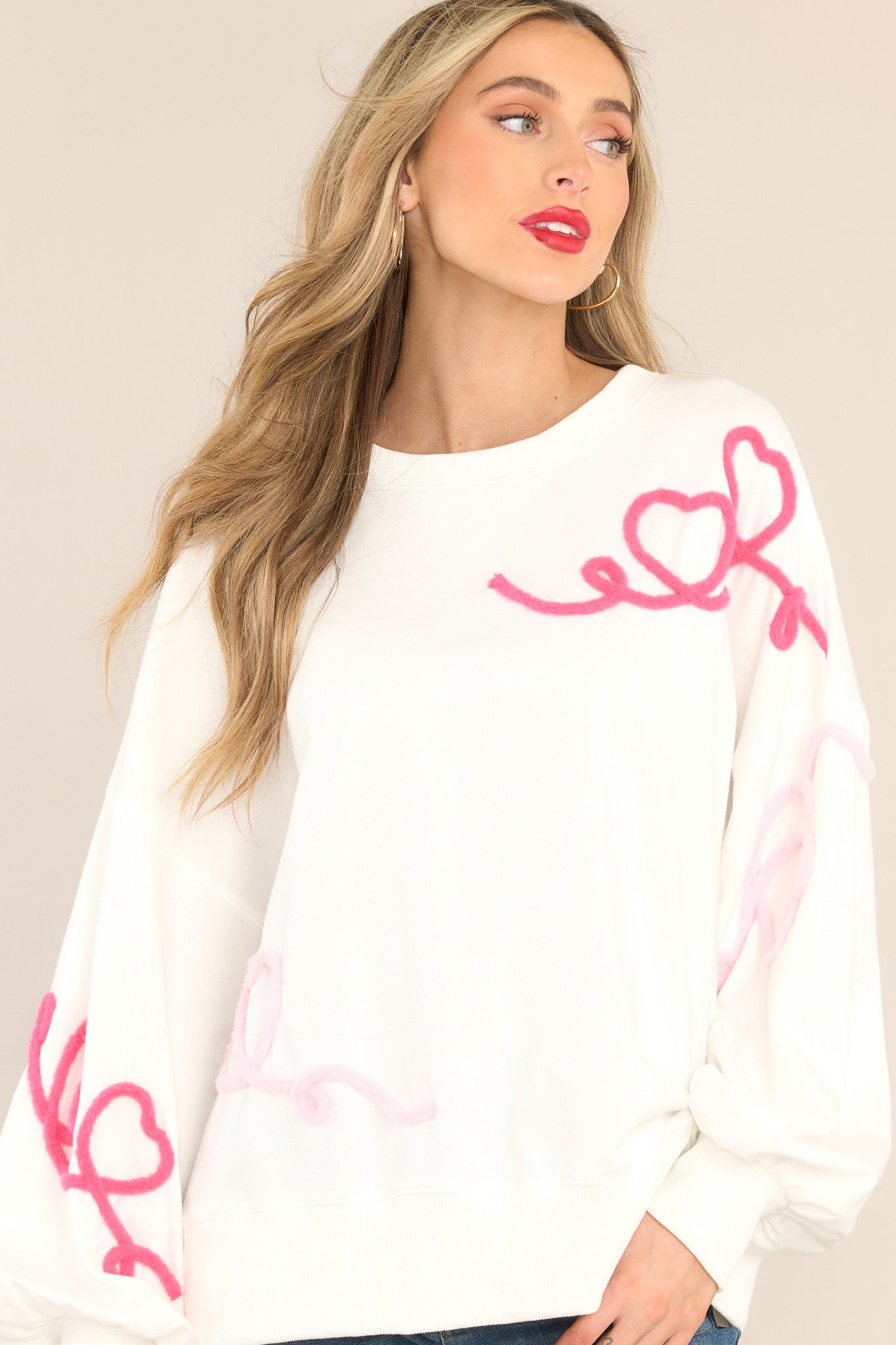 Front view of this sweatshirt that features textured whimsical heart detailing.