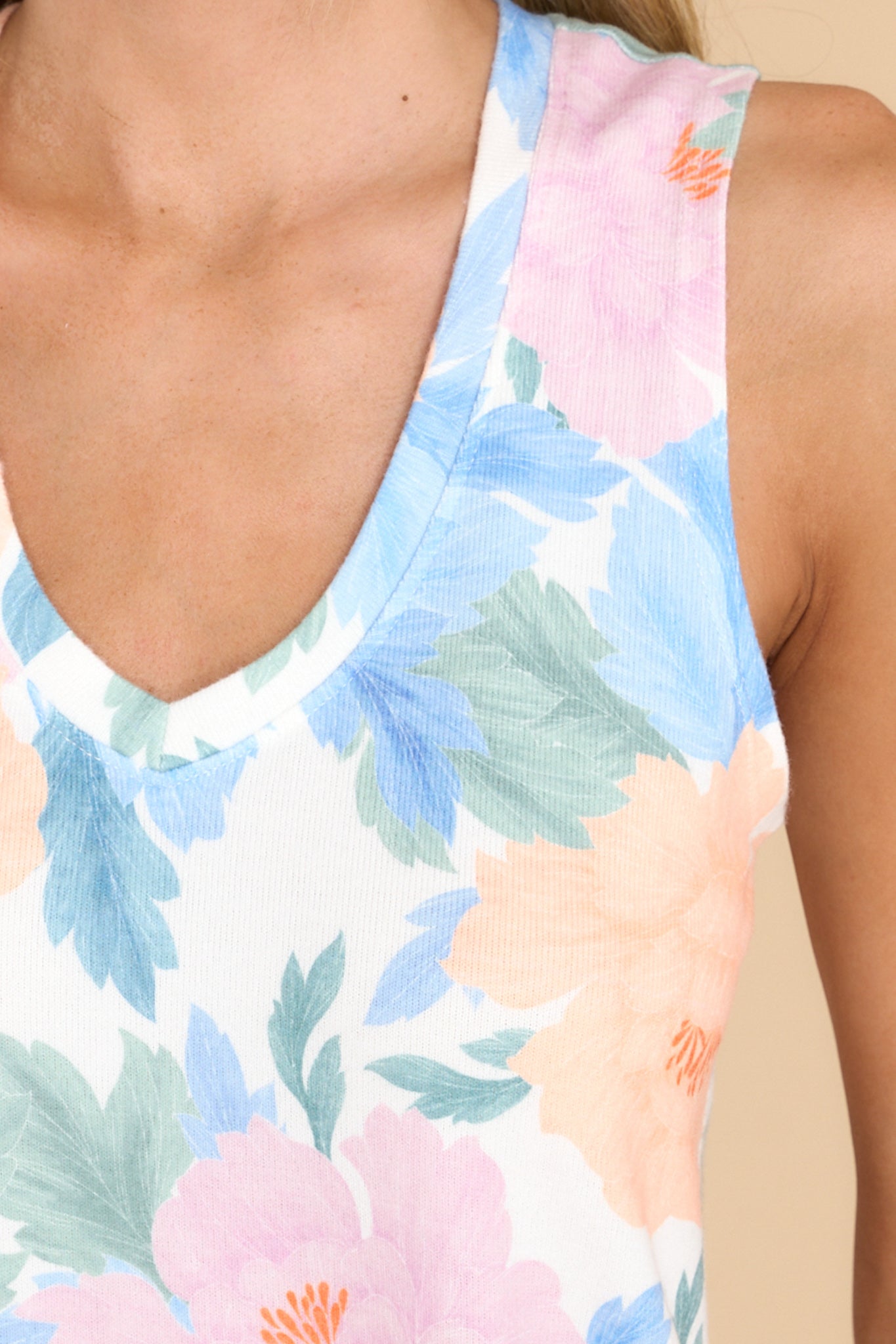 Close up view of this tank that features a v-neckline, a sleeveless design, a scoop bottom hem, and a super soft feel. 