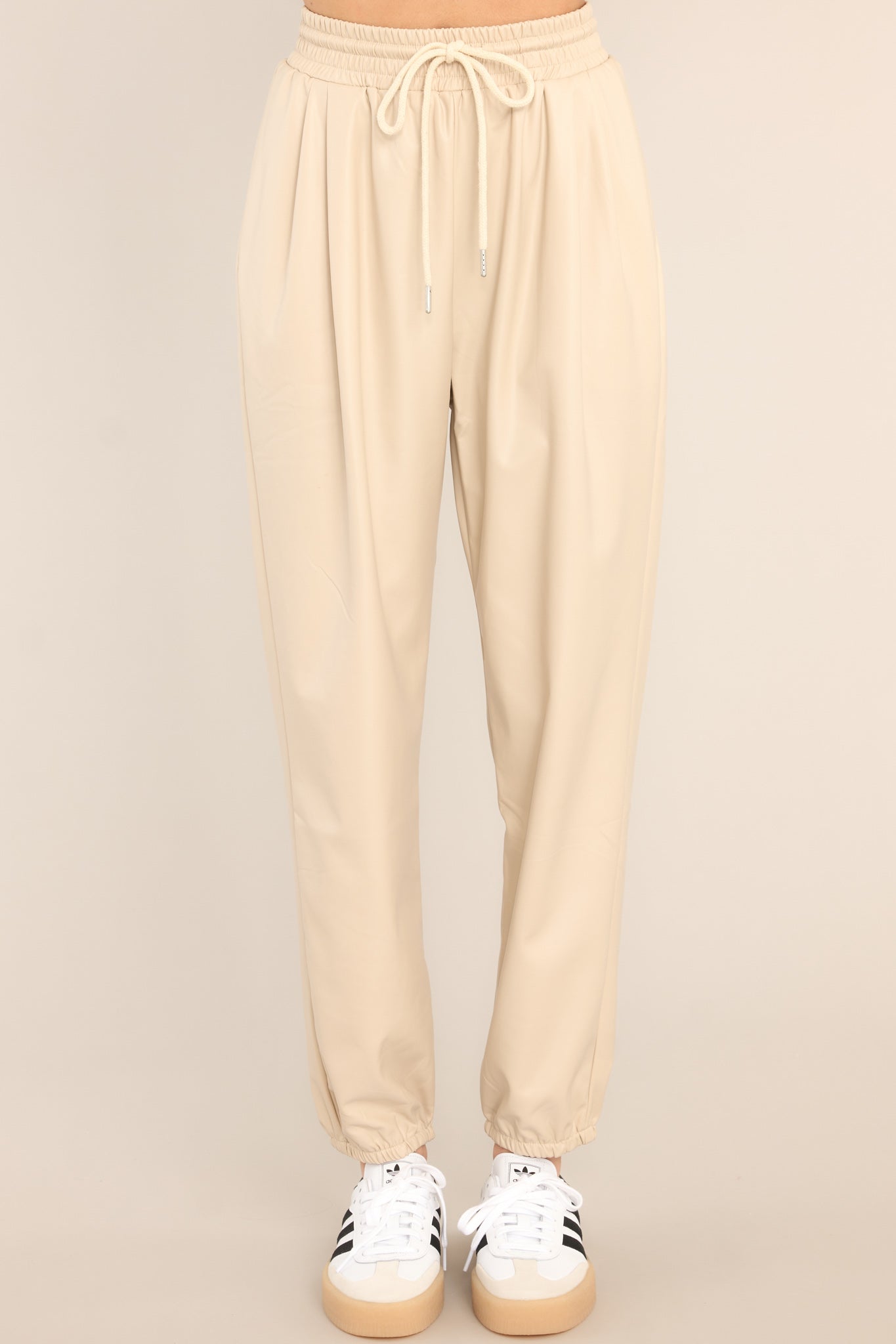 Front view of these pants that feature two functional pockets, adjustable drawstring waist, and elastic cuffs at the ankles.