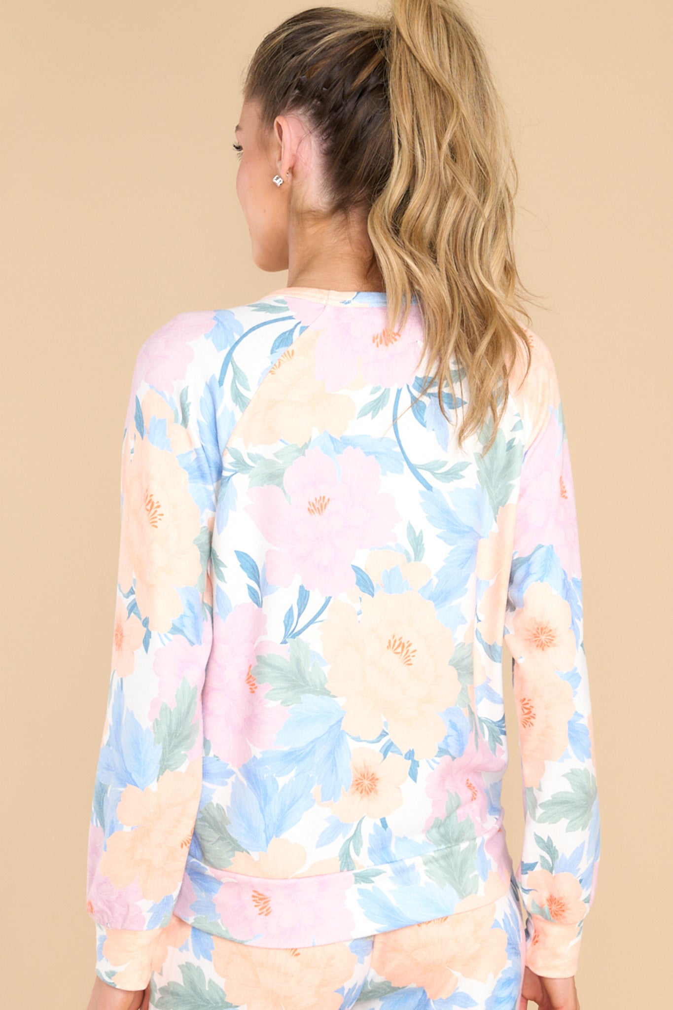 Back view of this top that features a crew neckline, long sleeves, and a super soft feel.