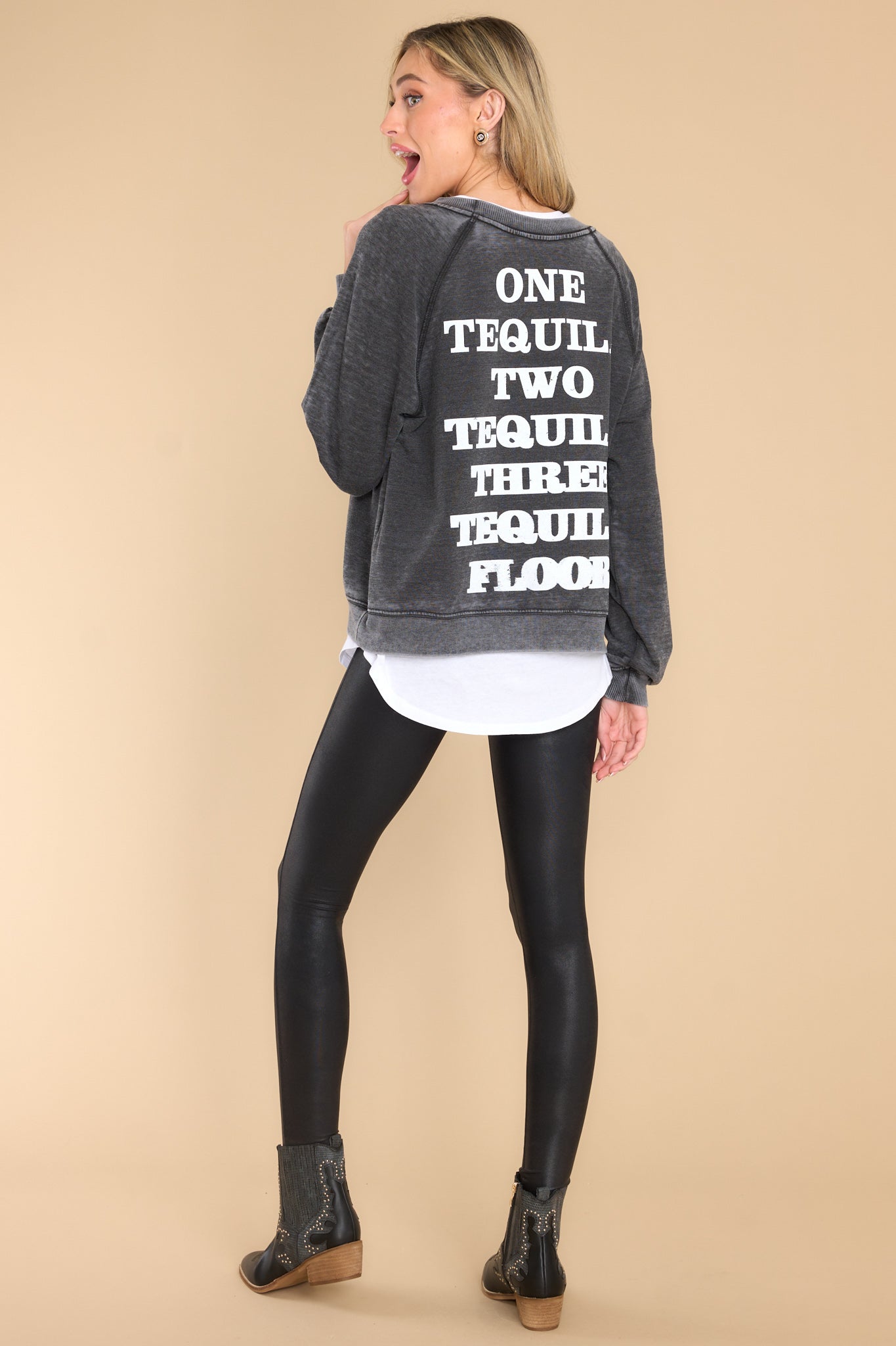 Back view of this sweatshirt that features text that says "ONE TEQUILA TWO TEQUILLA THREE TEQUILLA FLOOR."