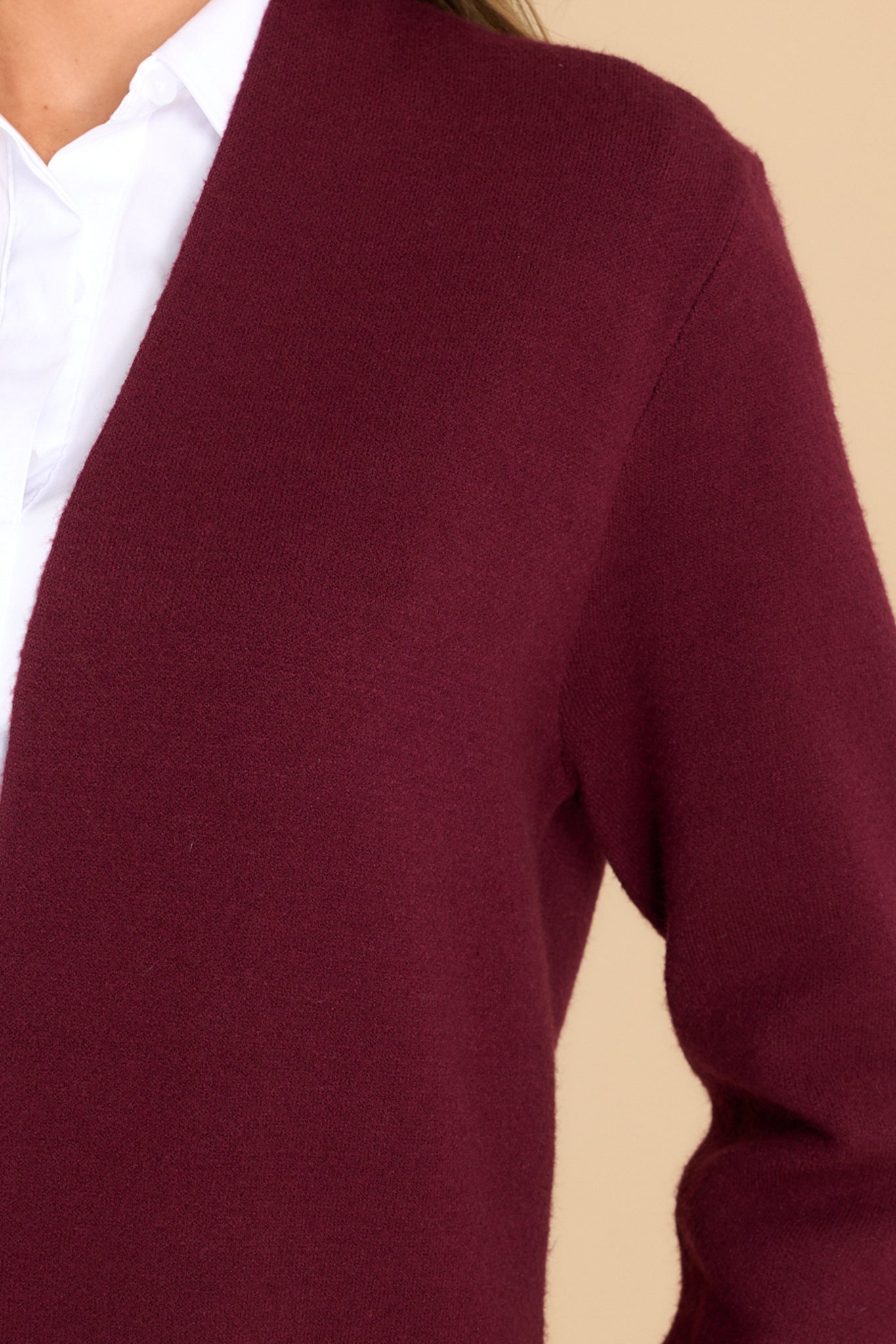 Close up view of this cardigan that features an open front design, two functional pockets, long sleeves, and a soft knit feel throughout.