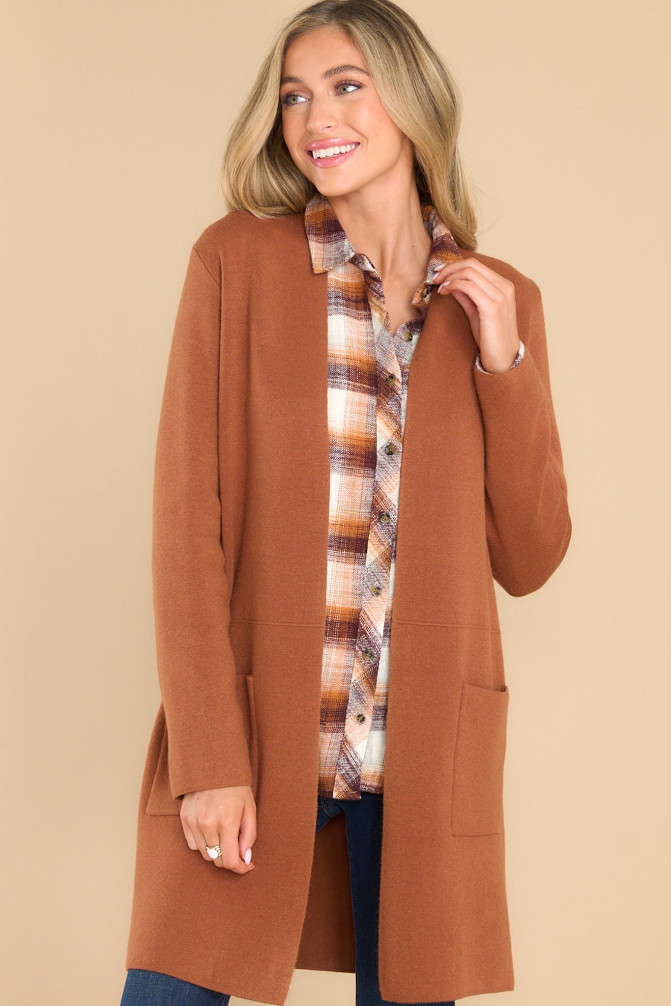 Front view of this cardigan that features an open front design, two functional pockets, long sleeves, and a soft knit feel throughout.