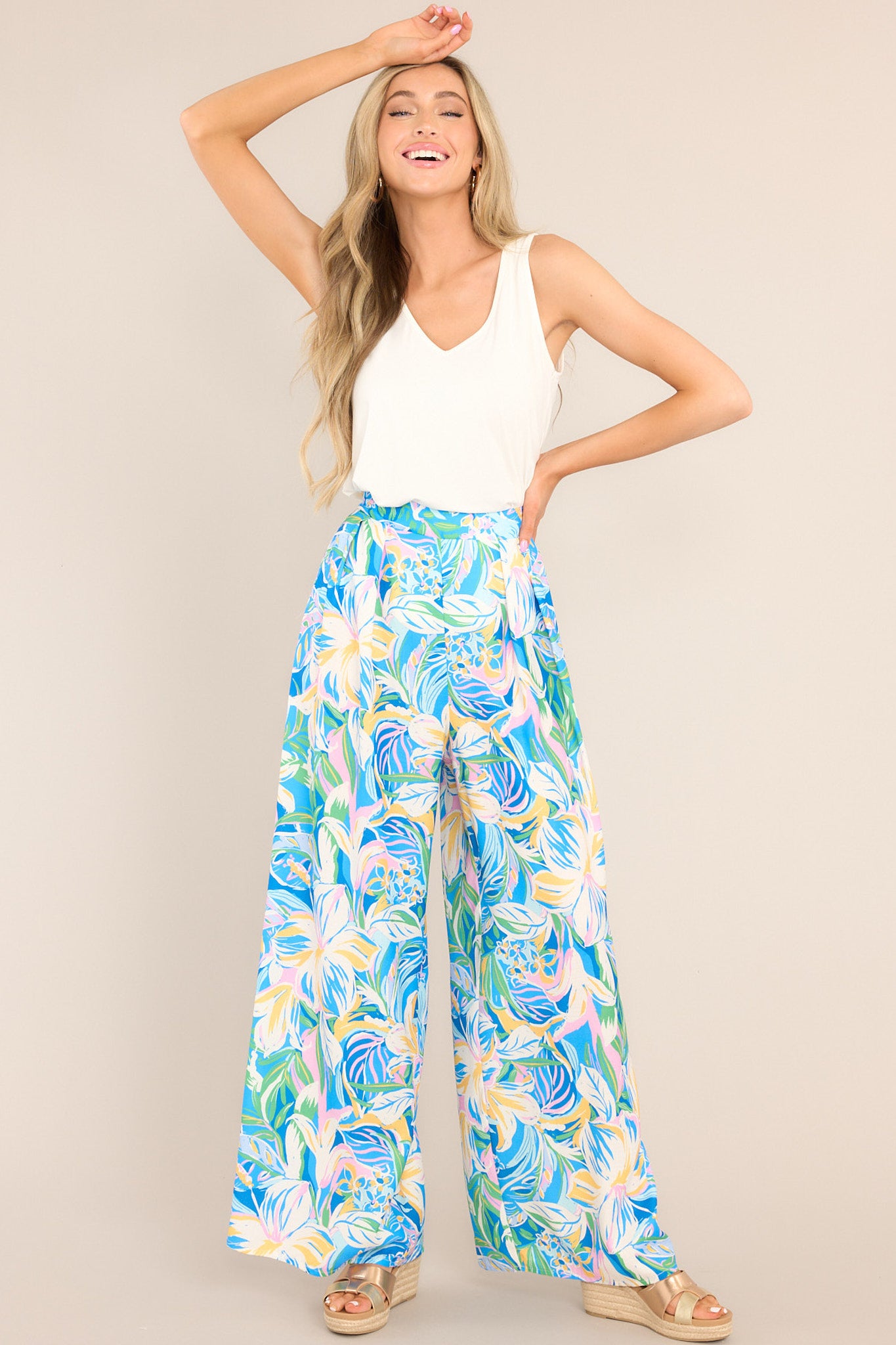 Full body view of these pants that feature a high-rise slip-on design, a waistband with elastic stretch in the back, and a flowy, wide-leg pant style.