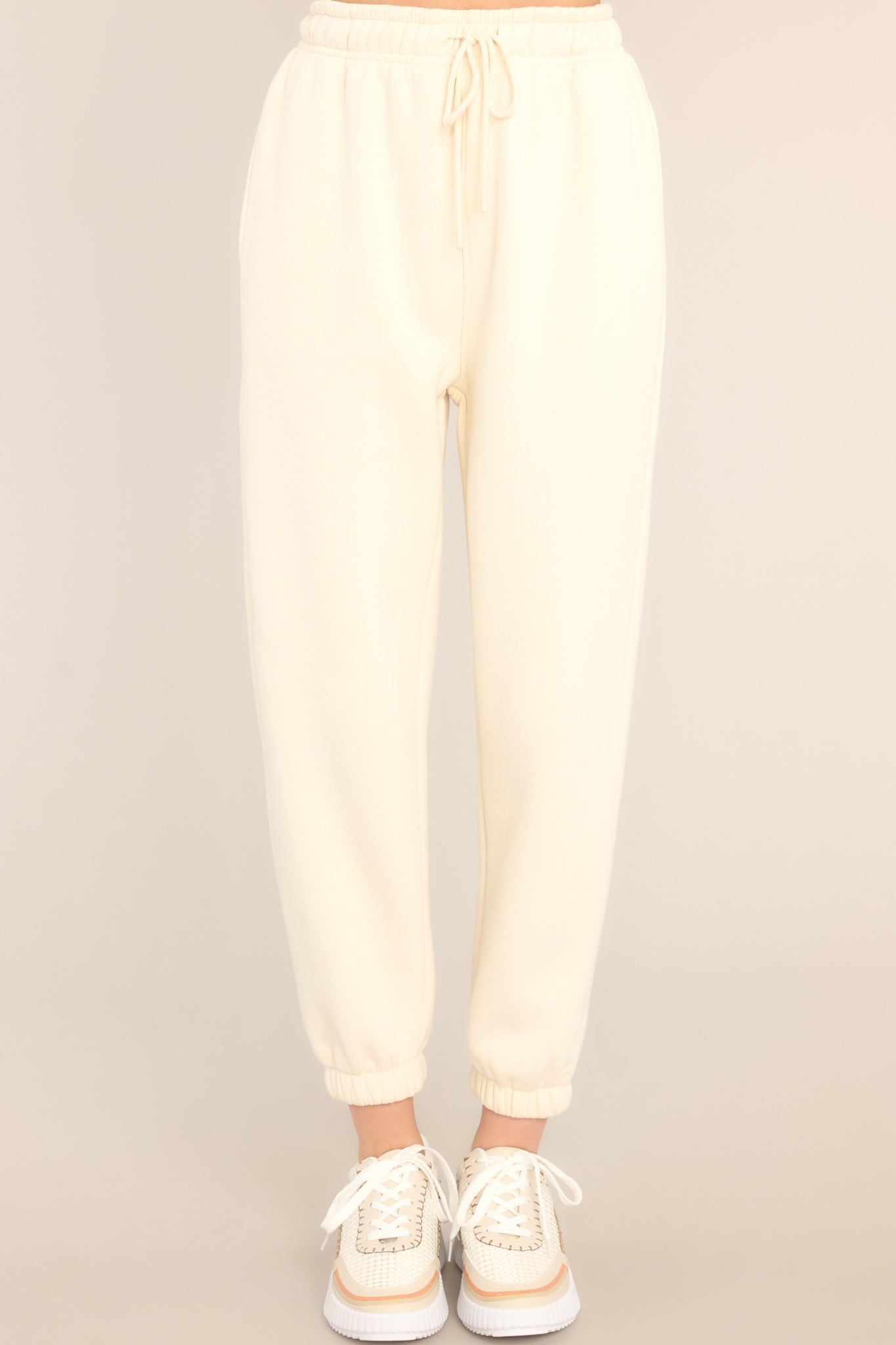 Front view of these joggers that feature a self-tie drawstring waist, pockets, and cuffed elastic ankles.