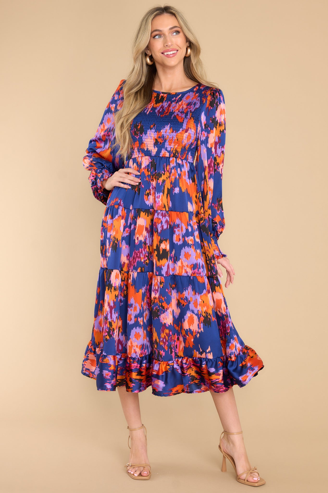 Full body view of this dress that showcases an abstract print in shades of pink, orange, and purple.