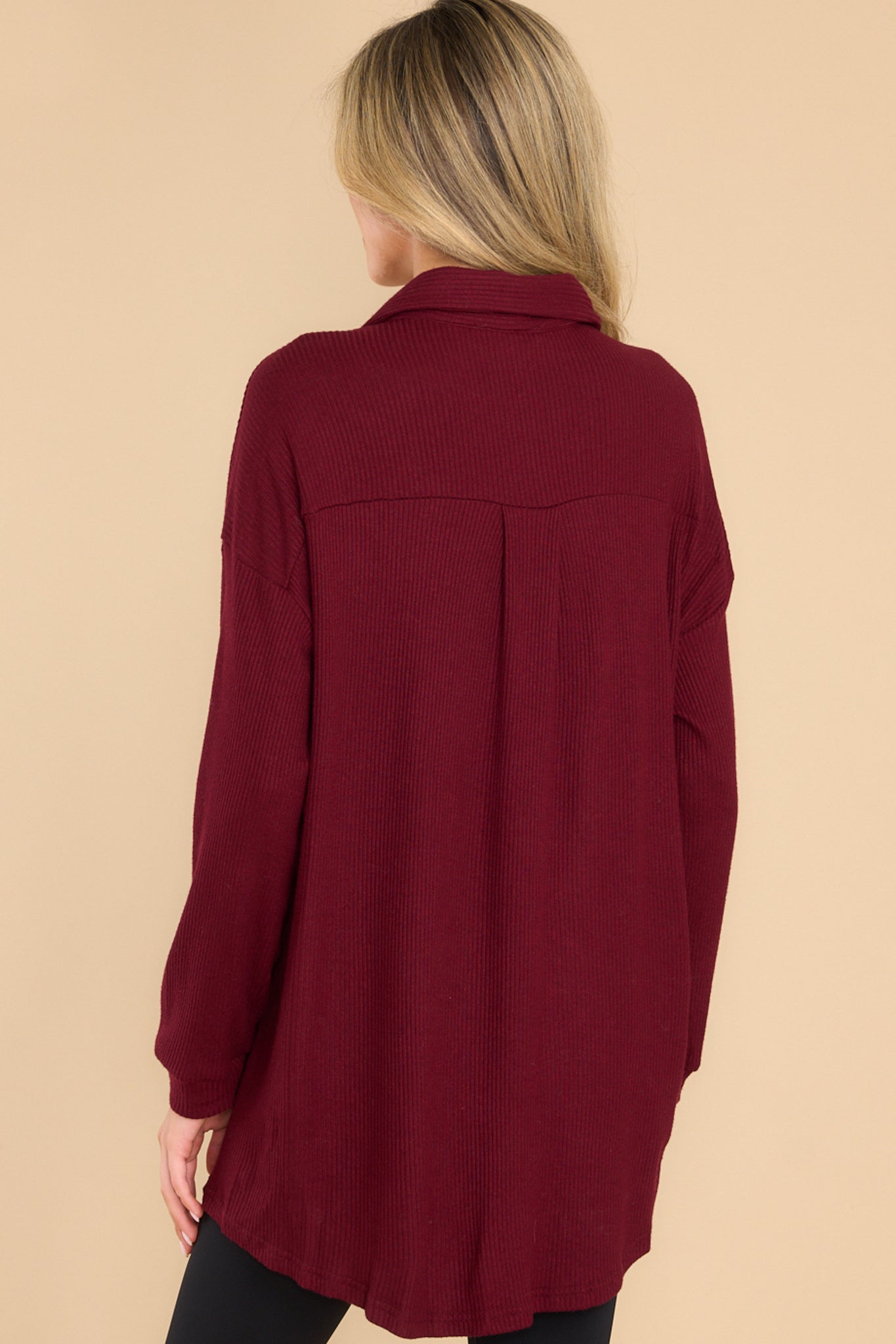 Back view of this top that features button-down closures on the front, a collared neckline, cuffed sleeves, and a chest pocket.