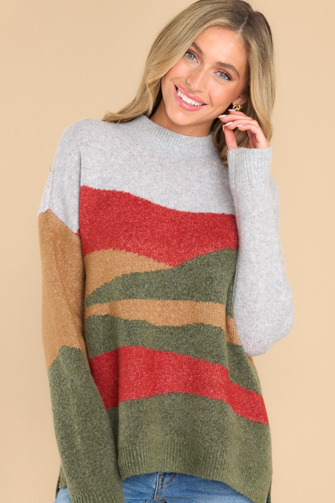 Front view of this sweater that features a crew neckline, a colorful pattern throughout, and long sleeves.