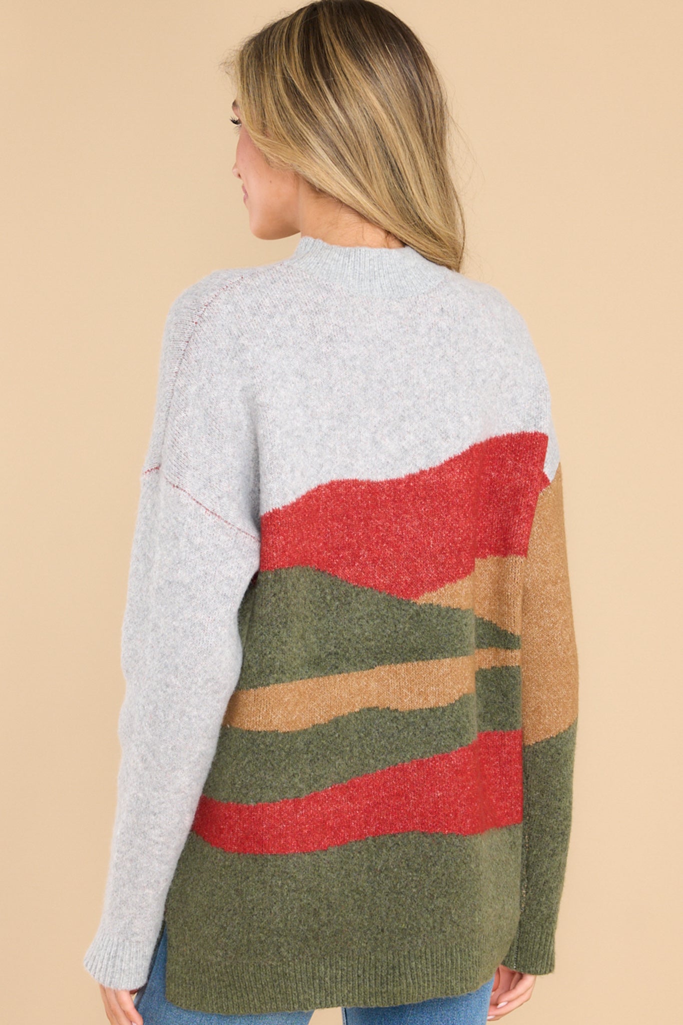 Back view of this sweater that features a crew neckline, a colorful pattern throughout, and long sleeves.