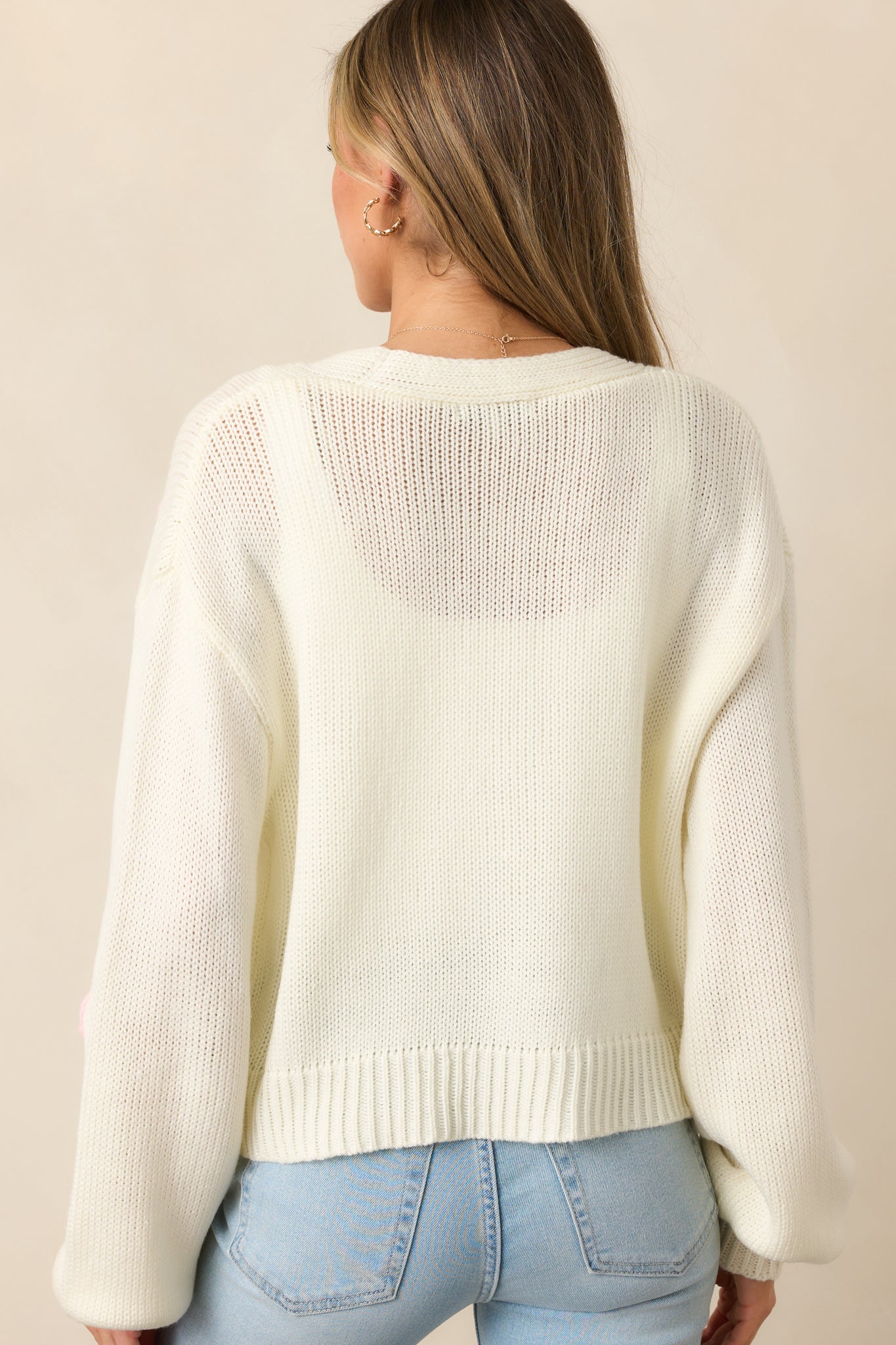 The back of this ivory cardigan keeps it simple with a clean, classic knit and a relaxed fit.