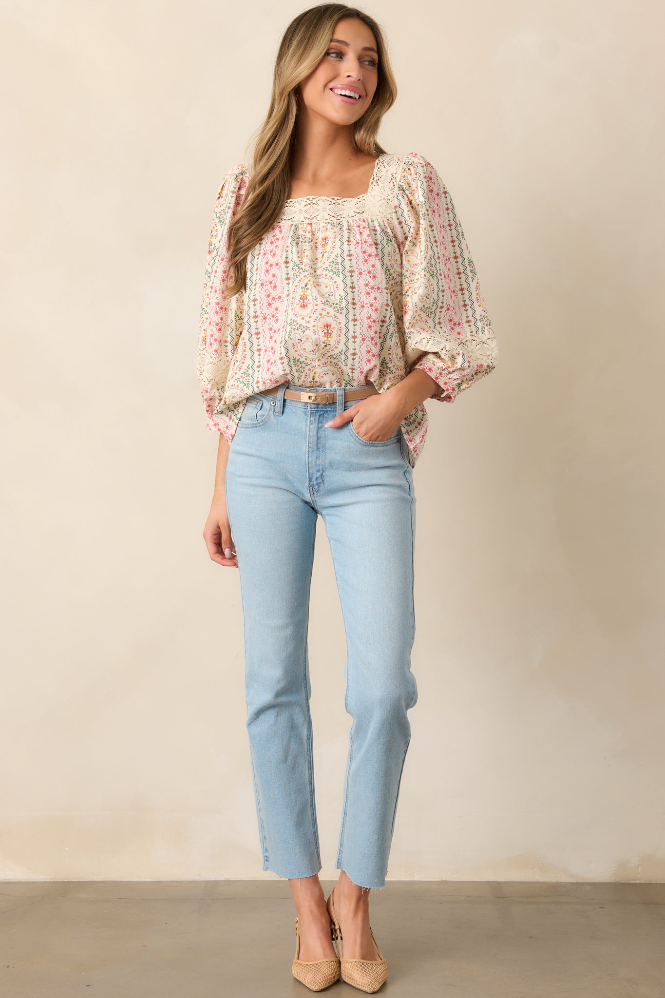  Flowy and feminine, this green blouse features a delicate floral design and breezy 3/4 sleeves.